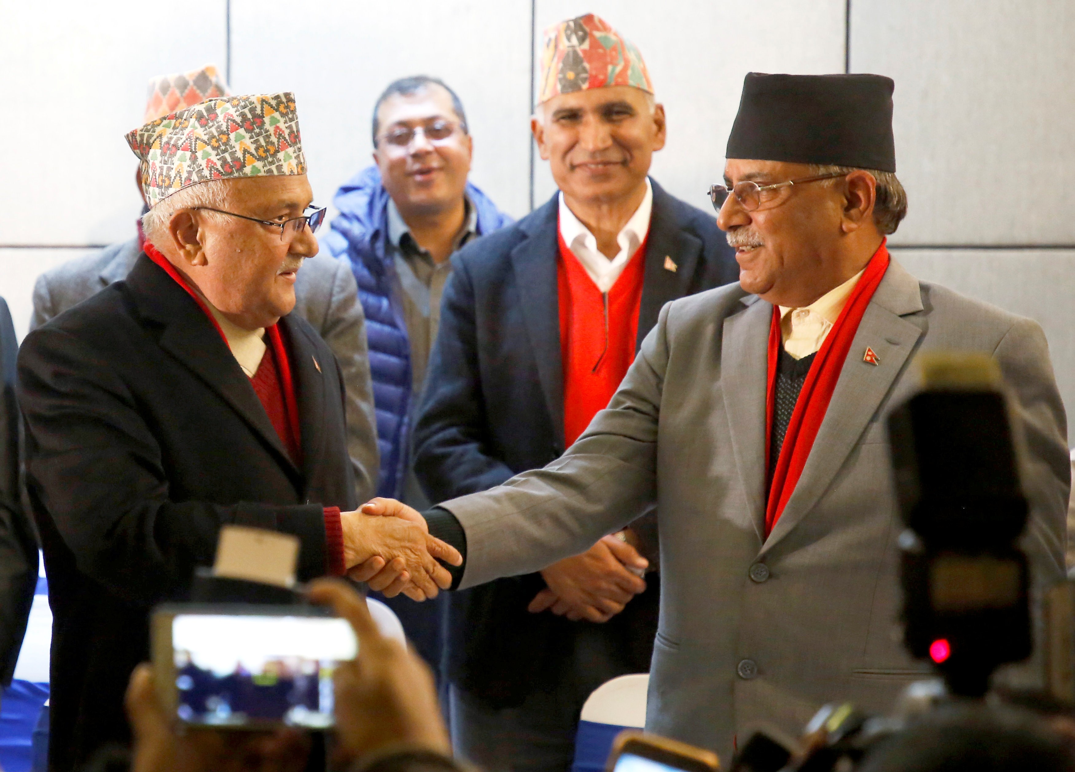 Khadga Prasad (K.P.) Sharma Oli (left), chairman of the Communist Party of Nepal (Unified Marxist-Leninist), greets Pushpa Kumar Dahal “Prachanda”, chairman of the Communist Party of Nepal (Maoist Centre), during a news conference in Kathmandu on December 17. Photo: Reuters