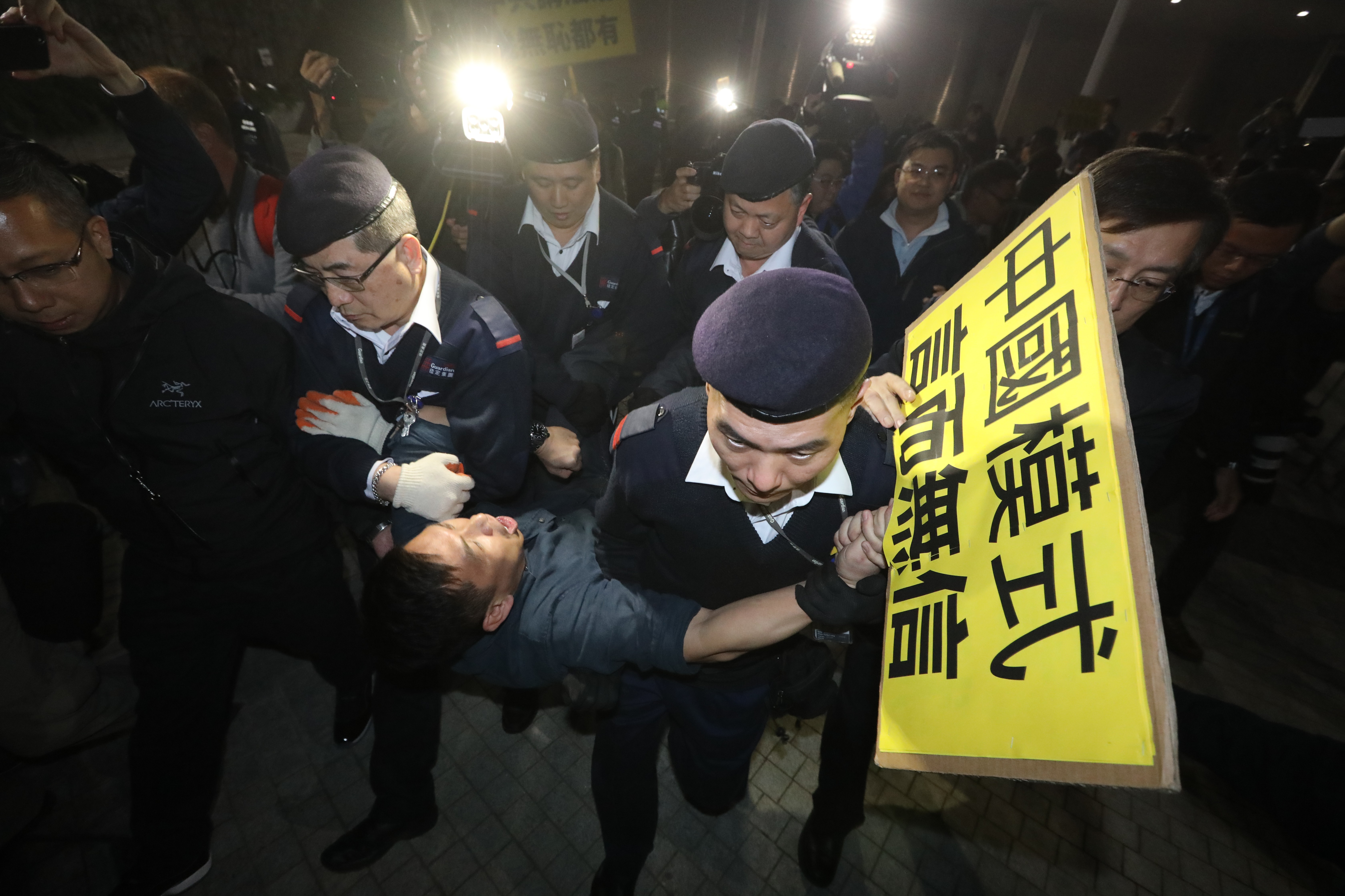 A protester who refused to leave is removed from Civic Square outside the government headquarters in Tamar. Photo: Sam Tsang