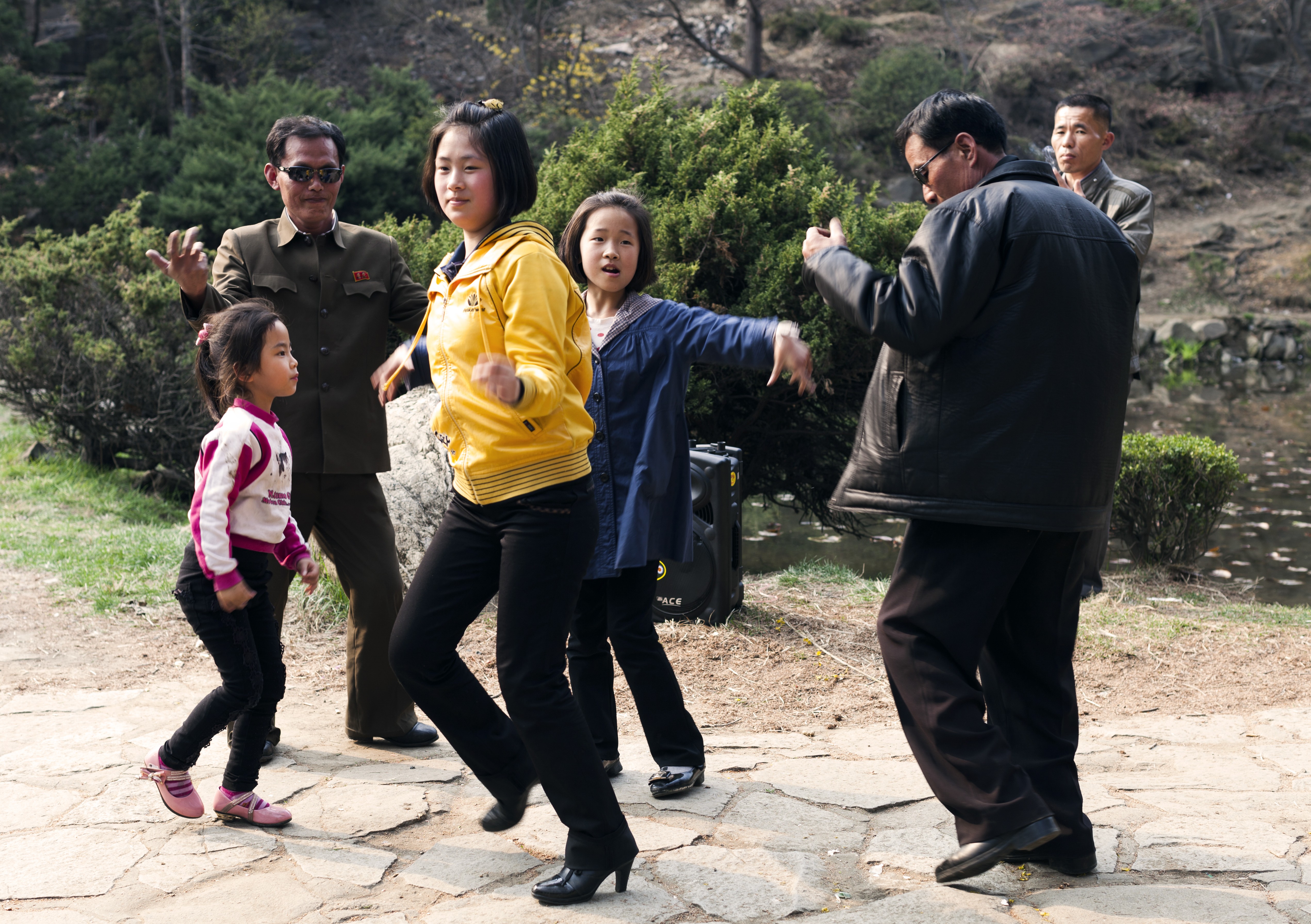 A family dances to music in Moranbong park, a popular spot in central Pyongyang. Locals gather here for barbecues and picnics and it is a favoured backdrop for wedding photos. Locals are thrilled when foreign visitors join in with the dancing.