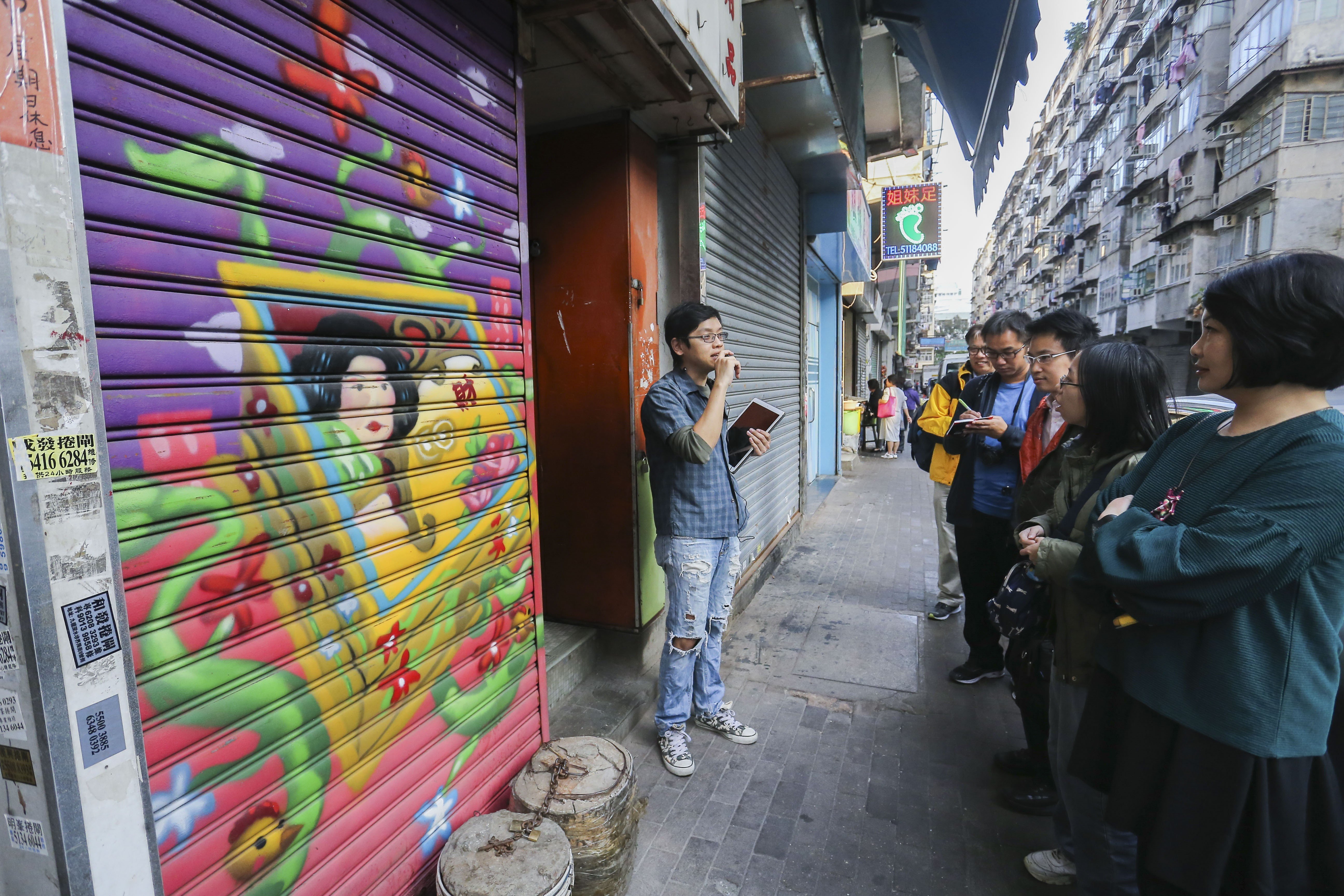 Stewart Cheng takes a small group out on his first art tour. Photo: Dickson Lee