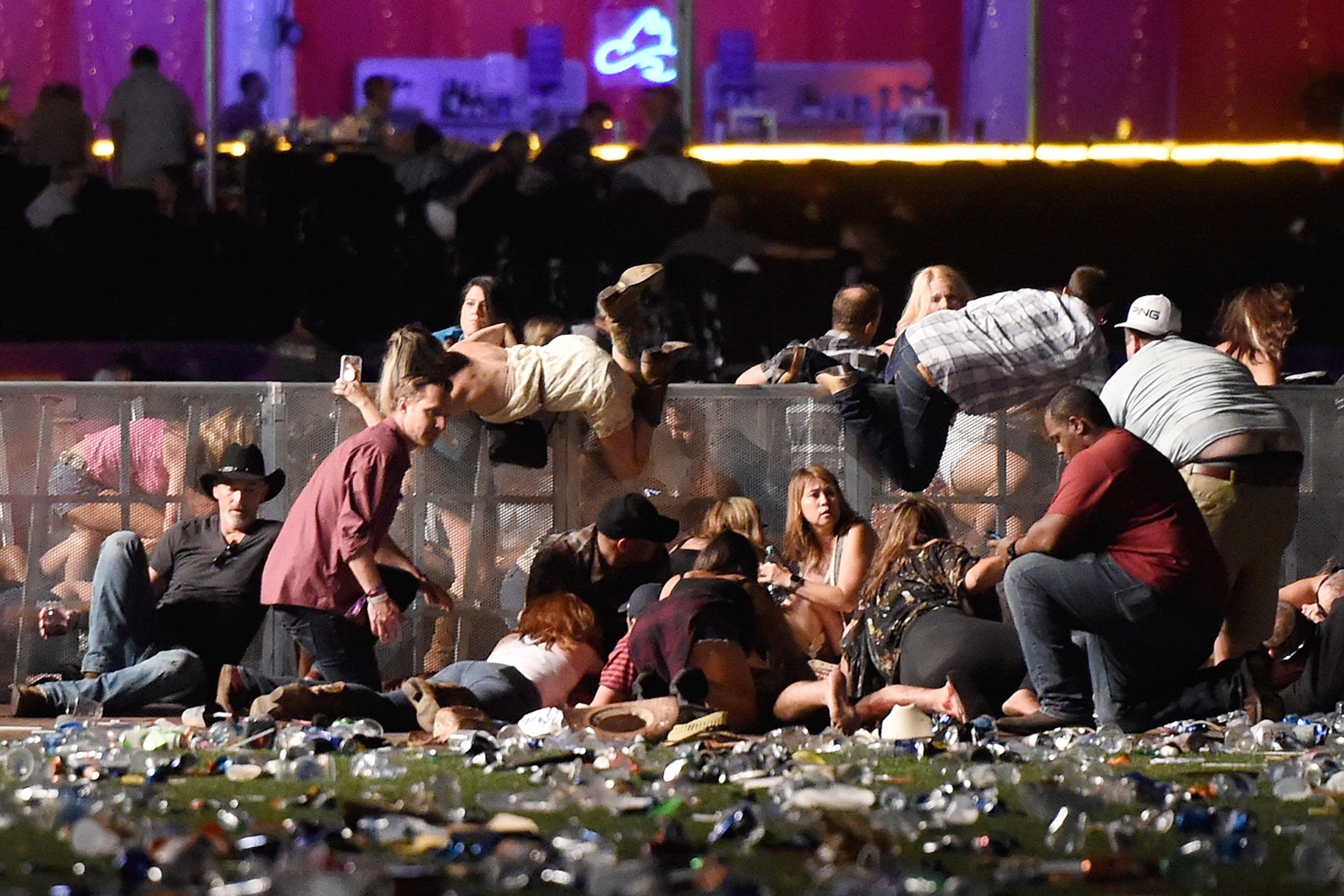 People scramble for shelter after gun fire was heard on October 1, 2017 in Las Vegas. Photo: AFP