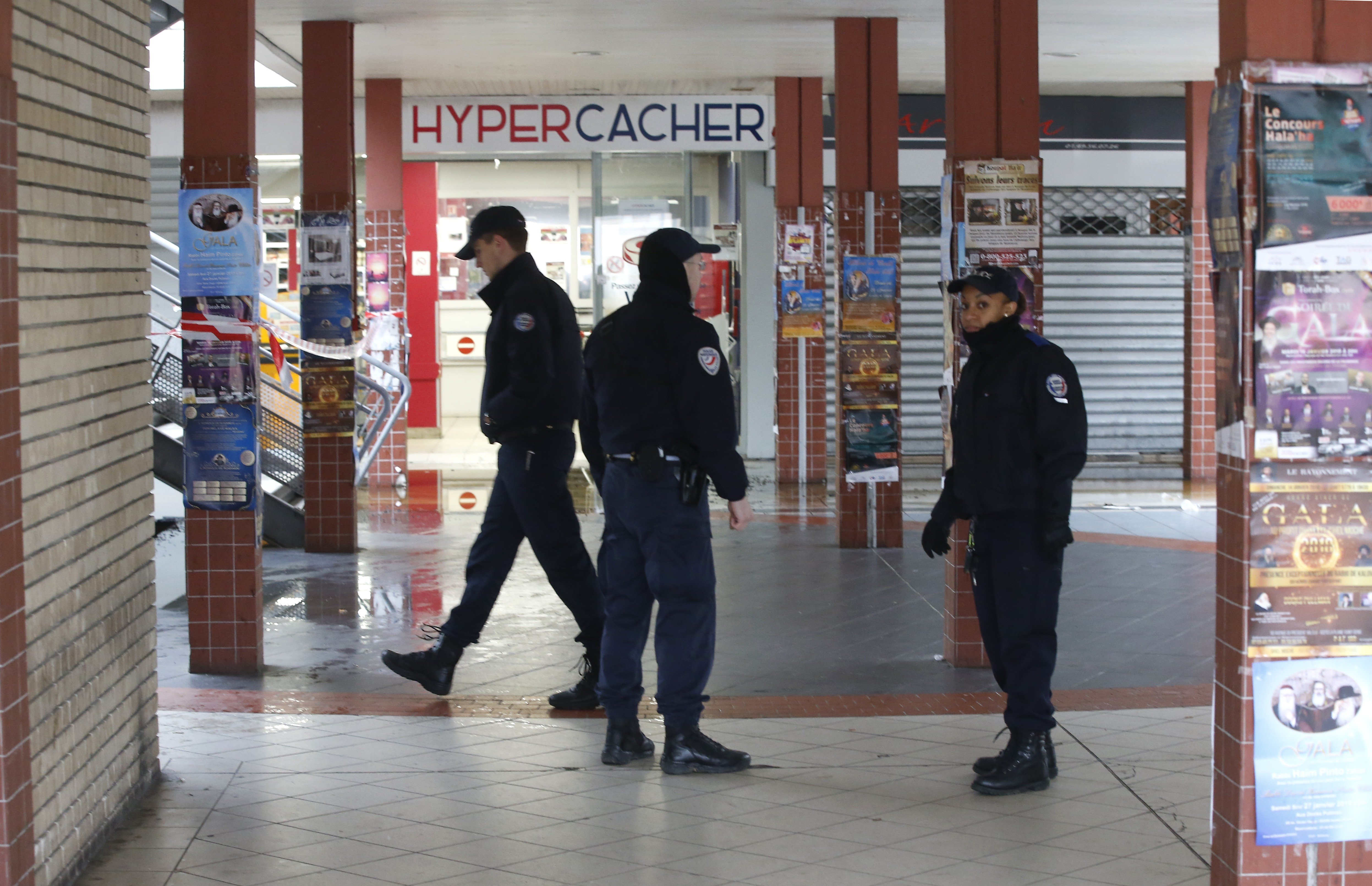 French police patrol outside the kosher market in Creteil, south of Paris, after a fire broke out on the anniversary of the 2015 terrorist attacks. Photo: AP