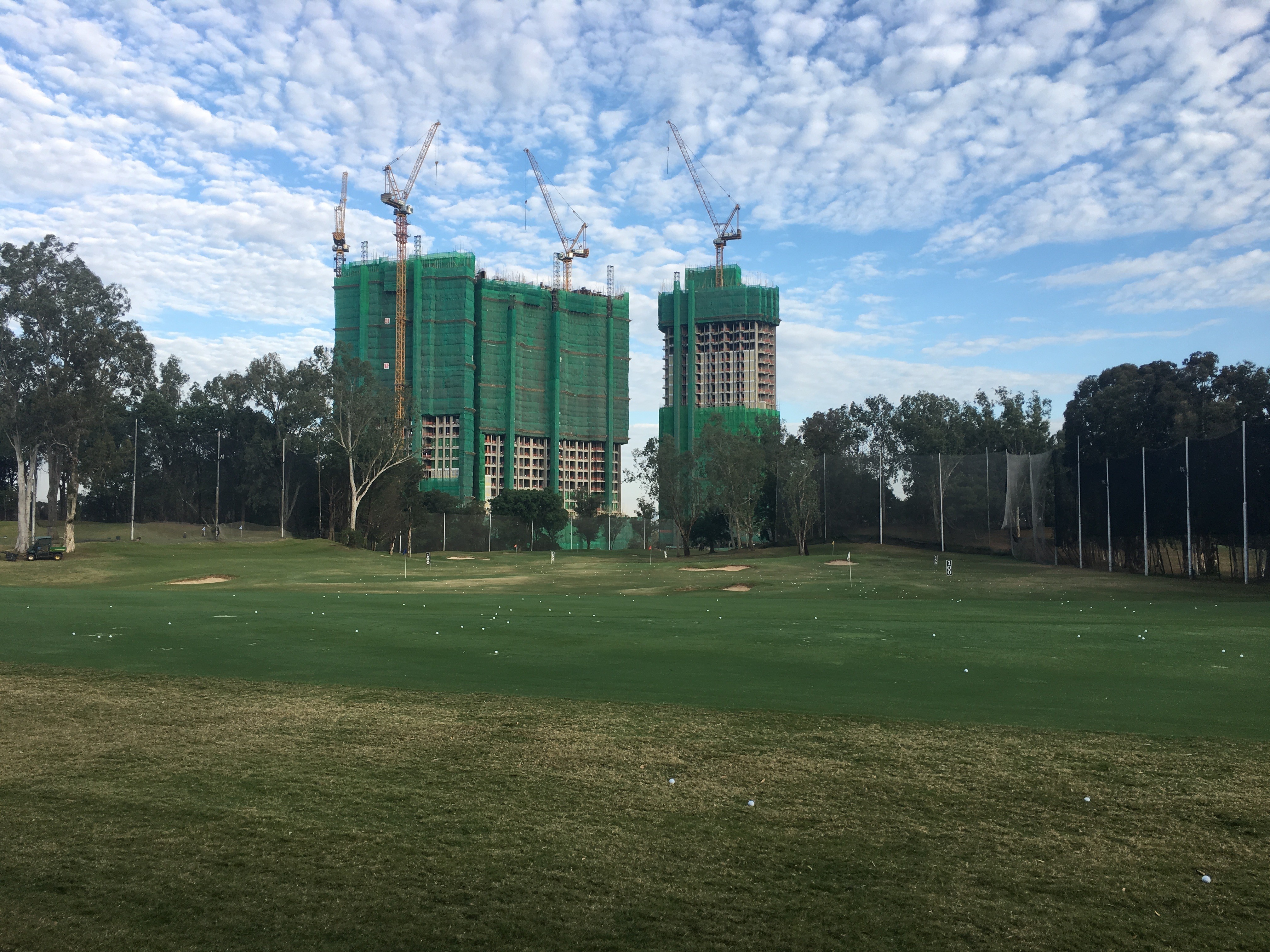A new housing development towers over the driving range at Hong Kong Golf Club in Fanling. Photo: SCMP
