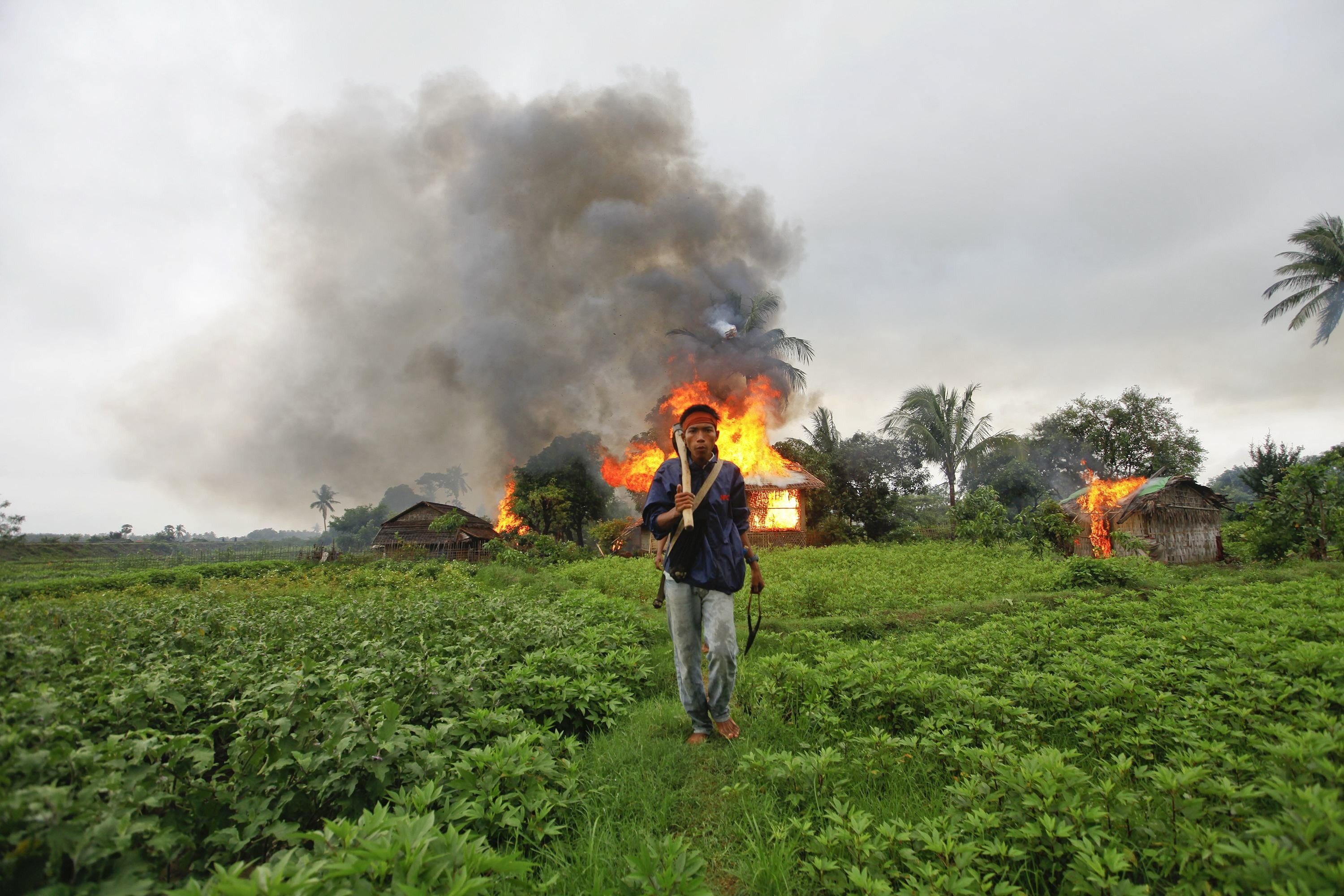 A Buddhist Rakhine man walks away from houses torched during fighting between Rakhine and Muslim Rohingya communities in the Rakhine State capital of Sittwe. Picture: Reuters