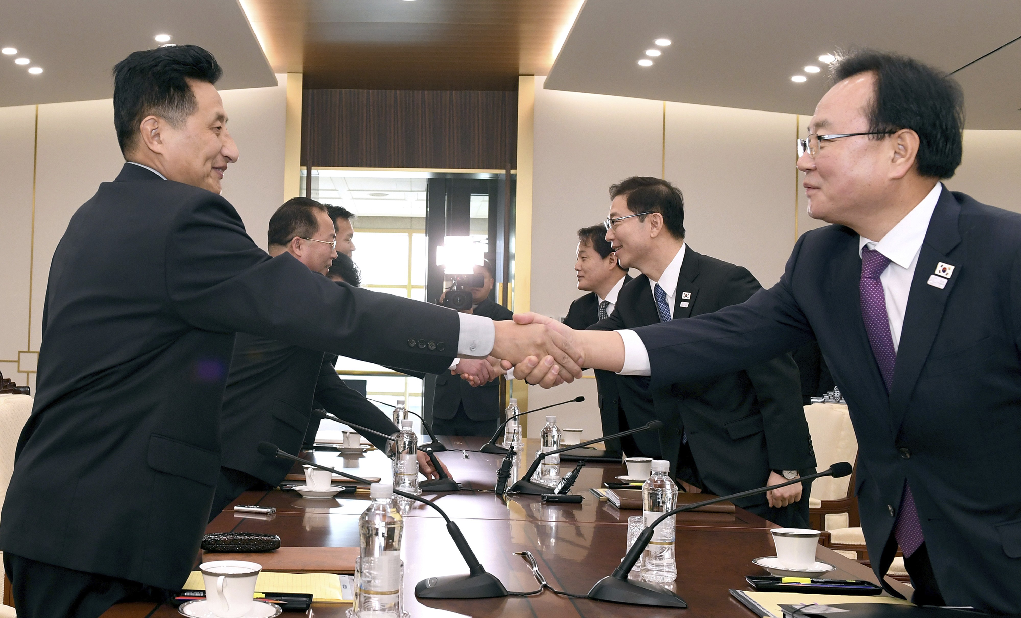 South Korean officials led by the vice-minister for unification Chun Hae-sung (centre right) shake hands with the North Korean delegation during their meeting at Panmunjom in the demilitarised zone in Paju, South Korea, on January 17. Photo: South Korean Unification Ministry via AP