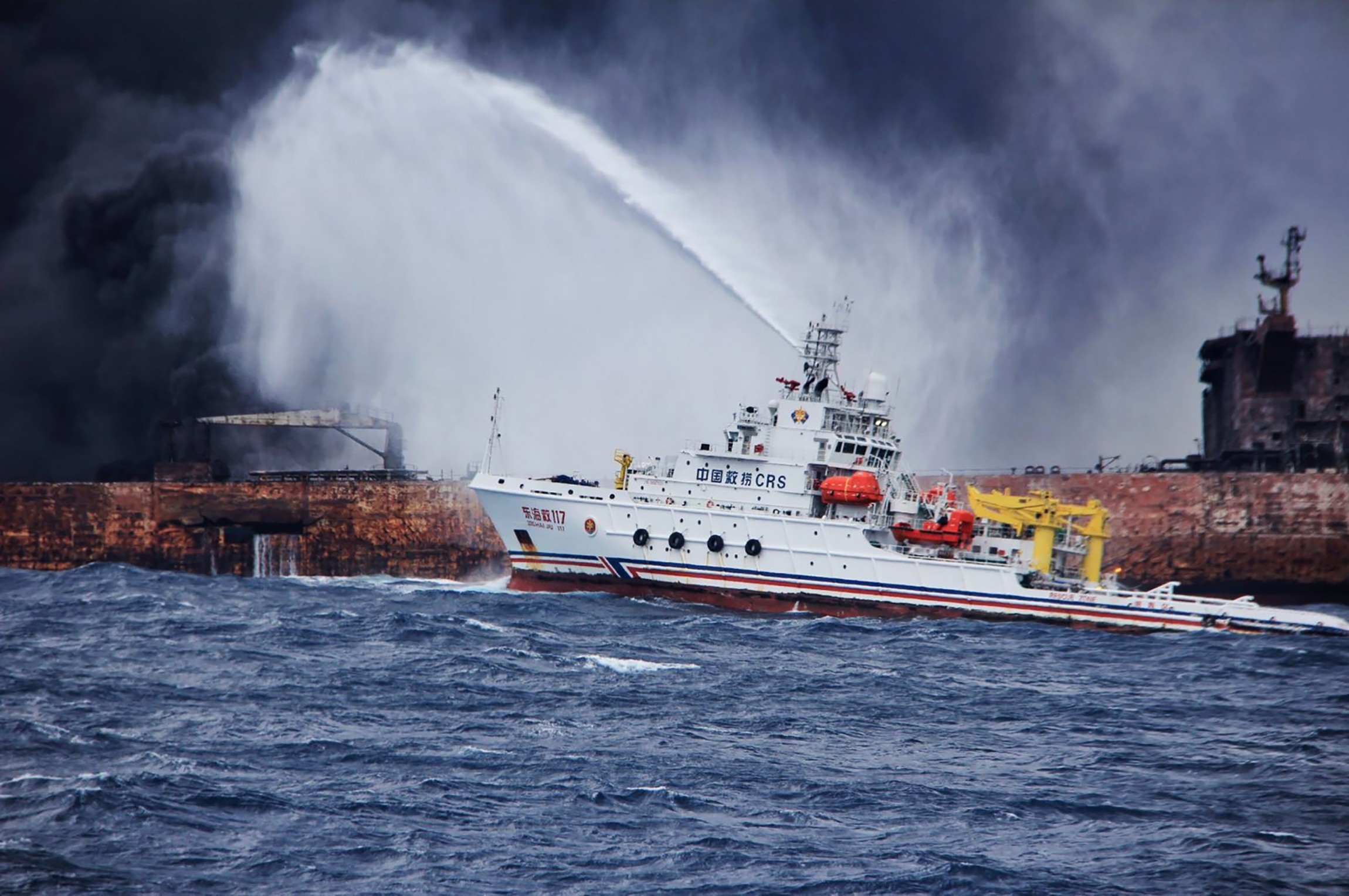 A Chinese firefighting vessel sprays foam on the burning oil tanker off the eastern coast of China. Photo: AFP