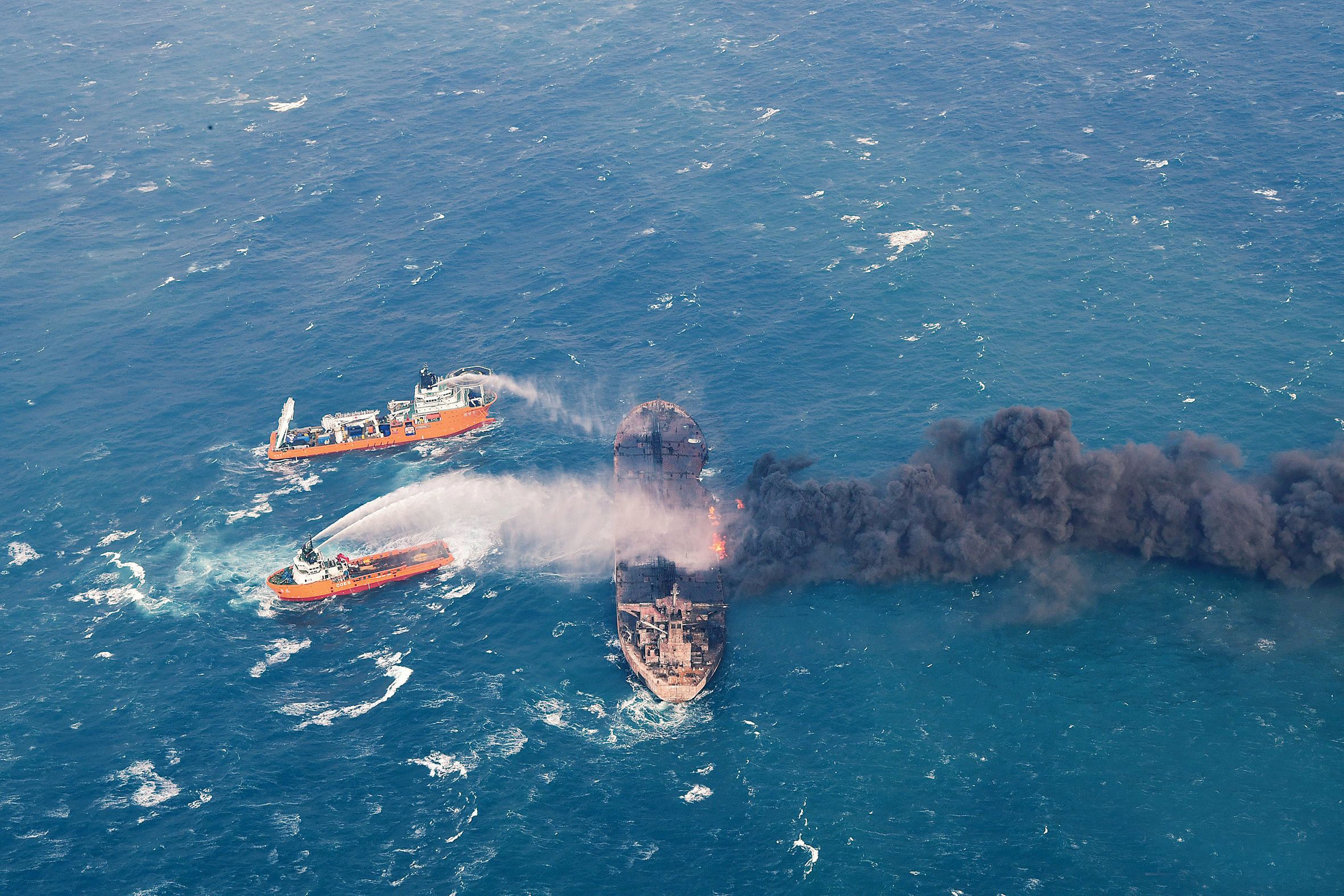 Emergency vessels work to put out an oil fire before the tanker Sanchi sank in the East China Sea. The slick has expanded to cover more than 330 sq km. Photo: AP