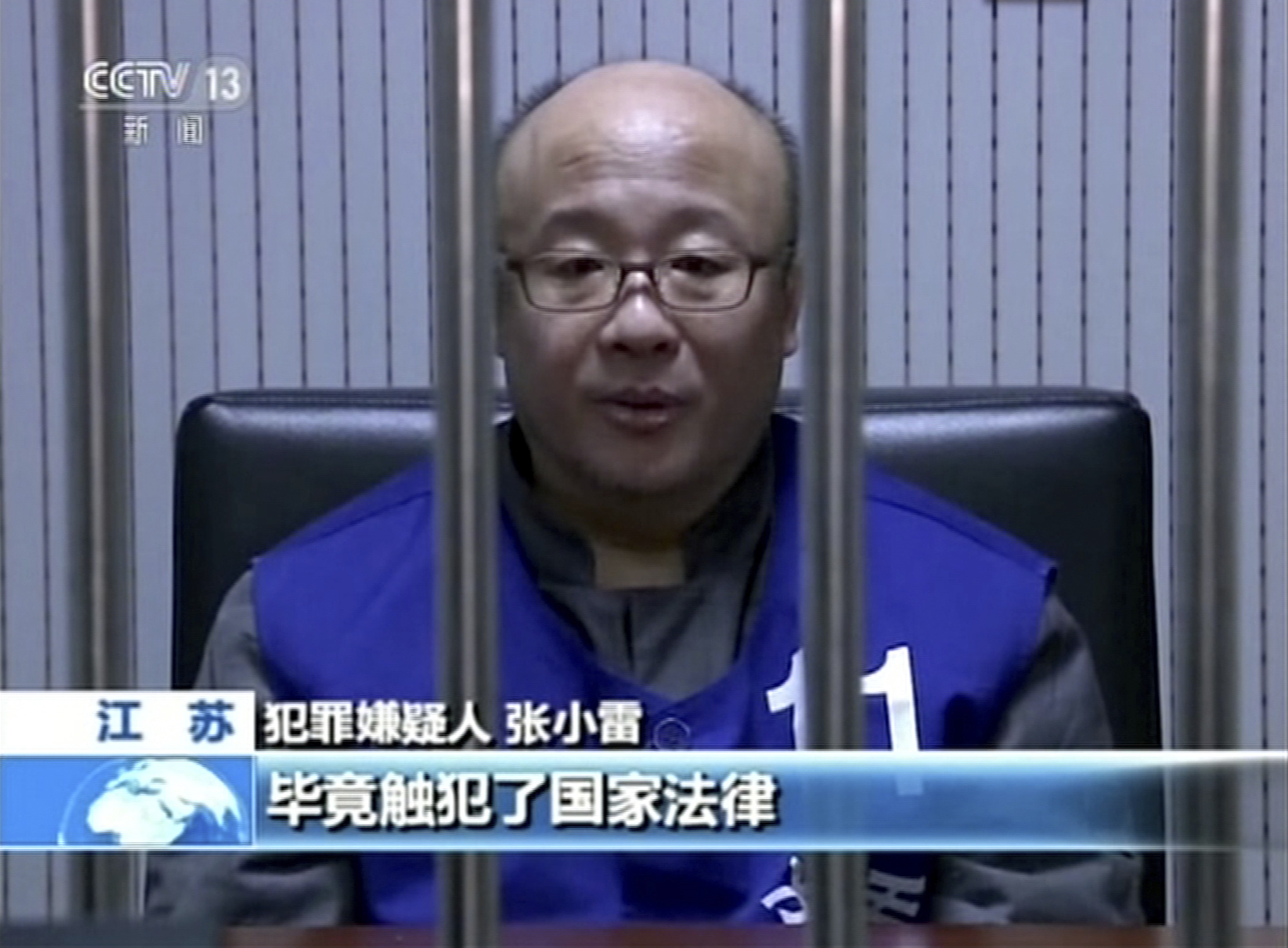 A still from state television shows the founder of the Ponzi scheme, Zhang Xiaolei, behind bars. Photo: Associated Press
