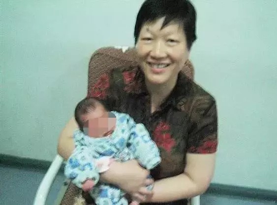 Li Guoqin pictured with one of the babies she has cared for. Photo: Weibo