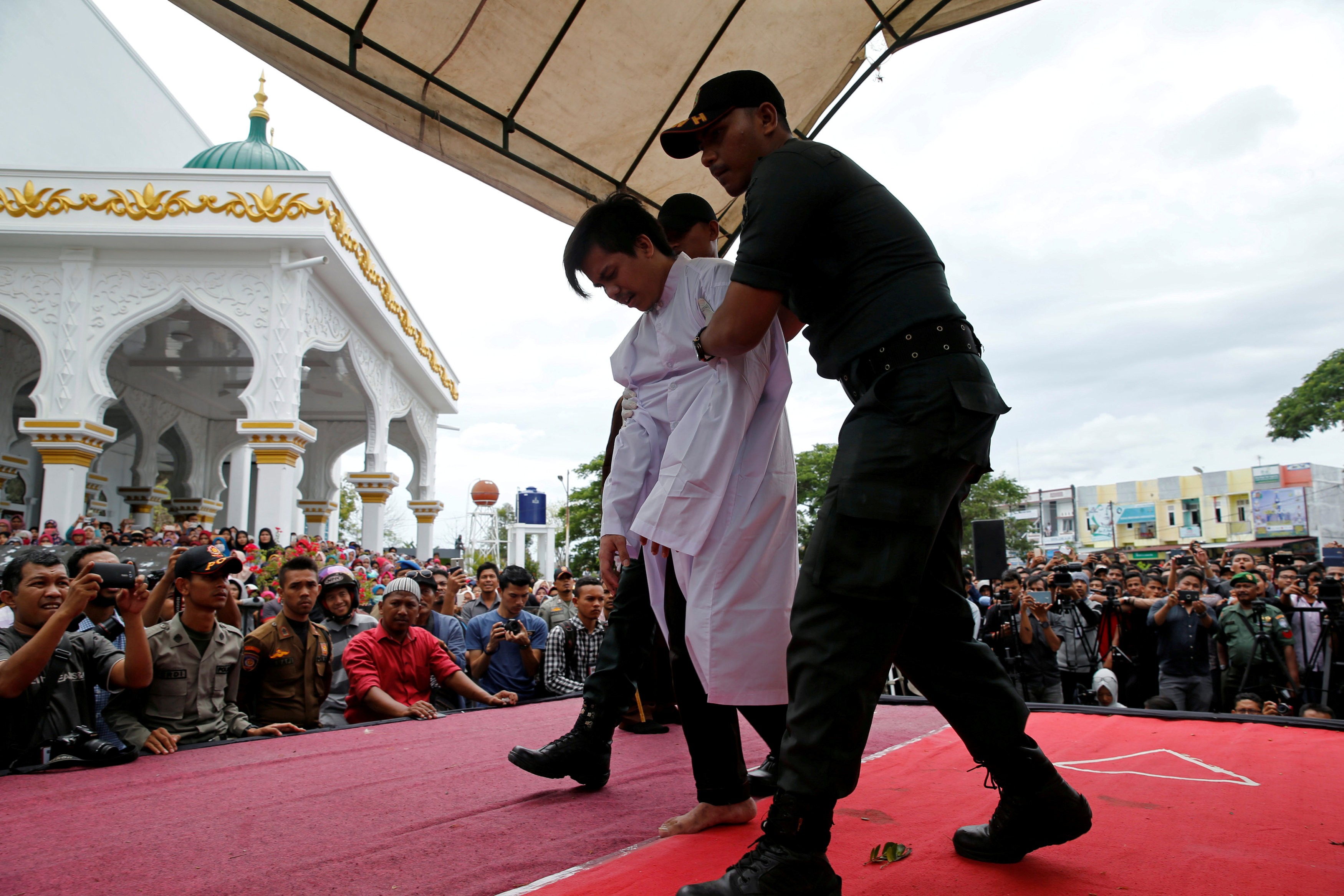 An Indonesian man is publicly caned for having gay sex. Photo: Reuters