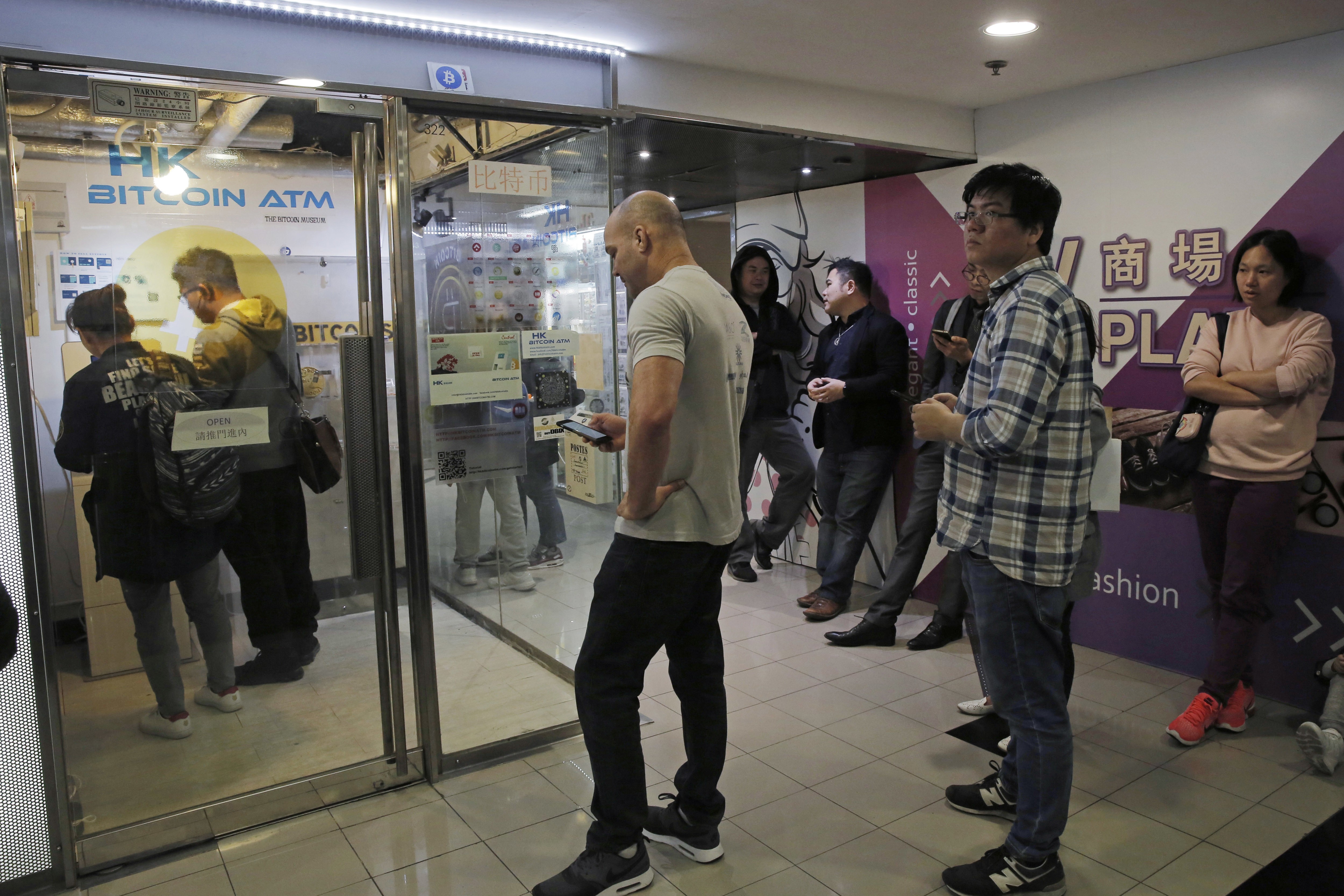 People lining up outside a bitcoin ATM in Hong Kong. Photo: AP