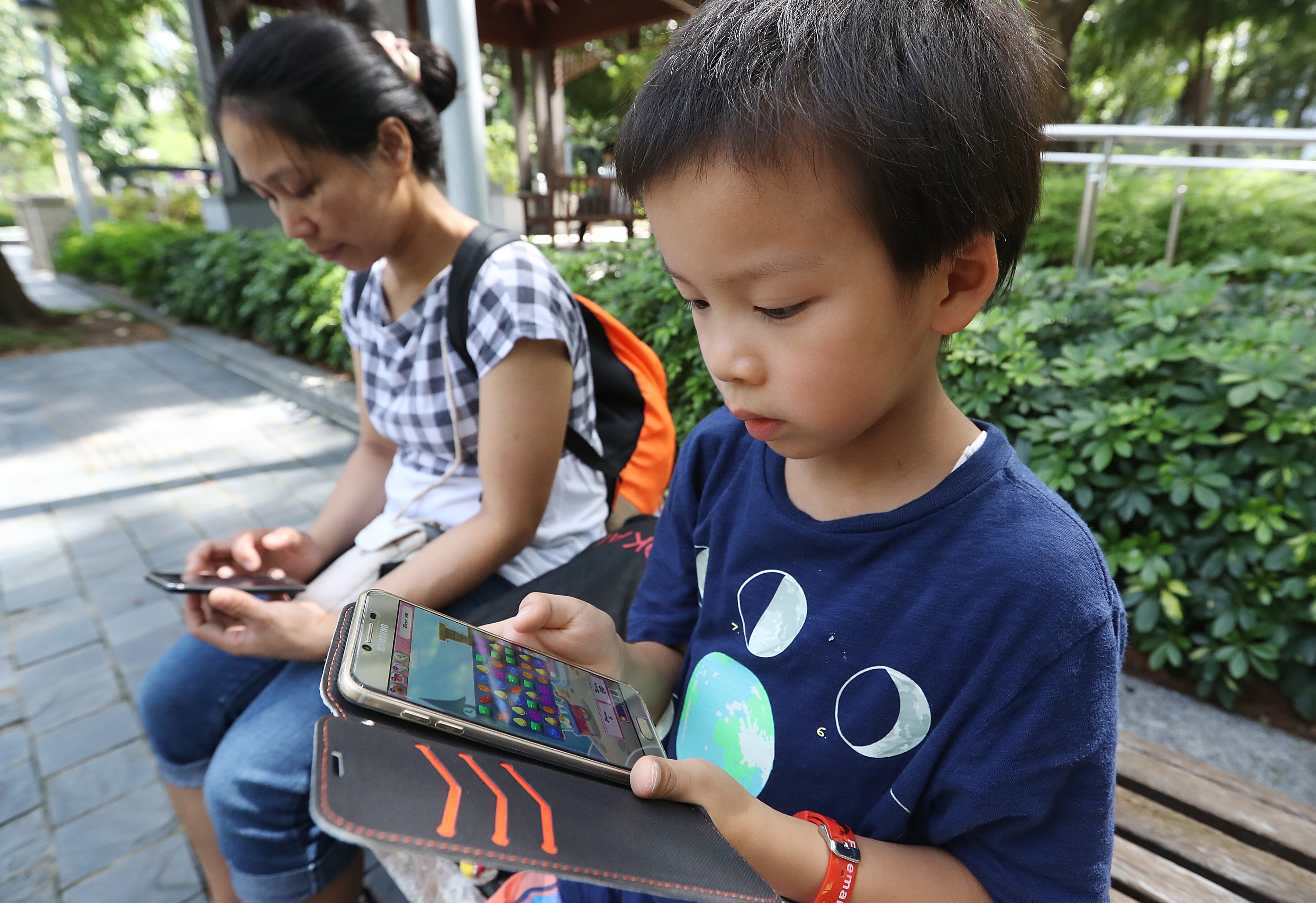 Mobile devices have become “essentials” for children nowadays. Photo: Edward Wong