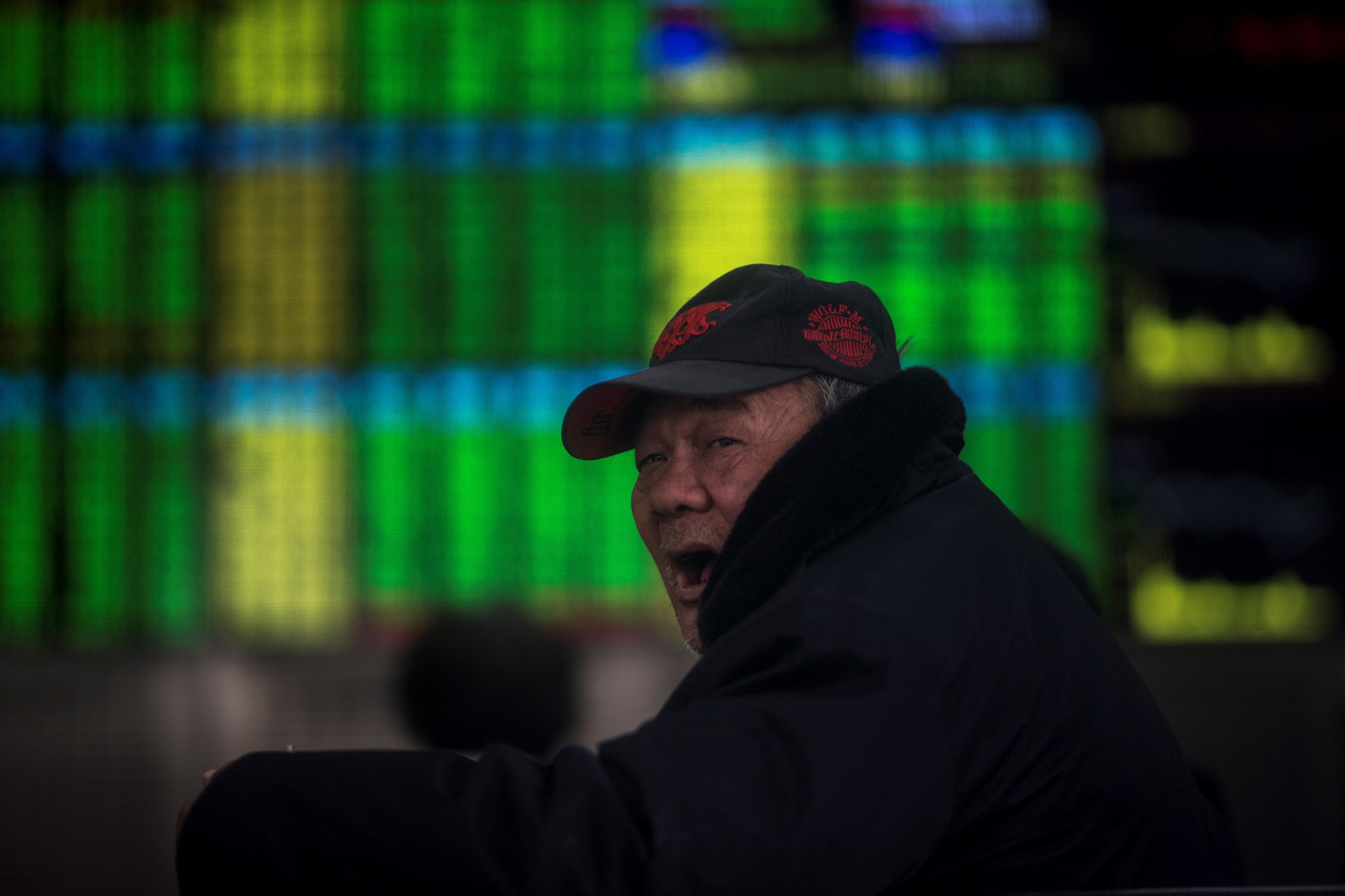 An investor reacts while keeping an eye on stock price movements in Shanghai. Photo: AFP
