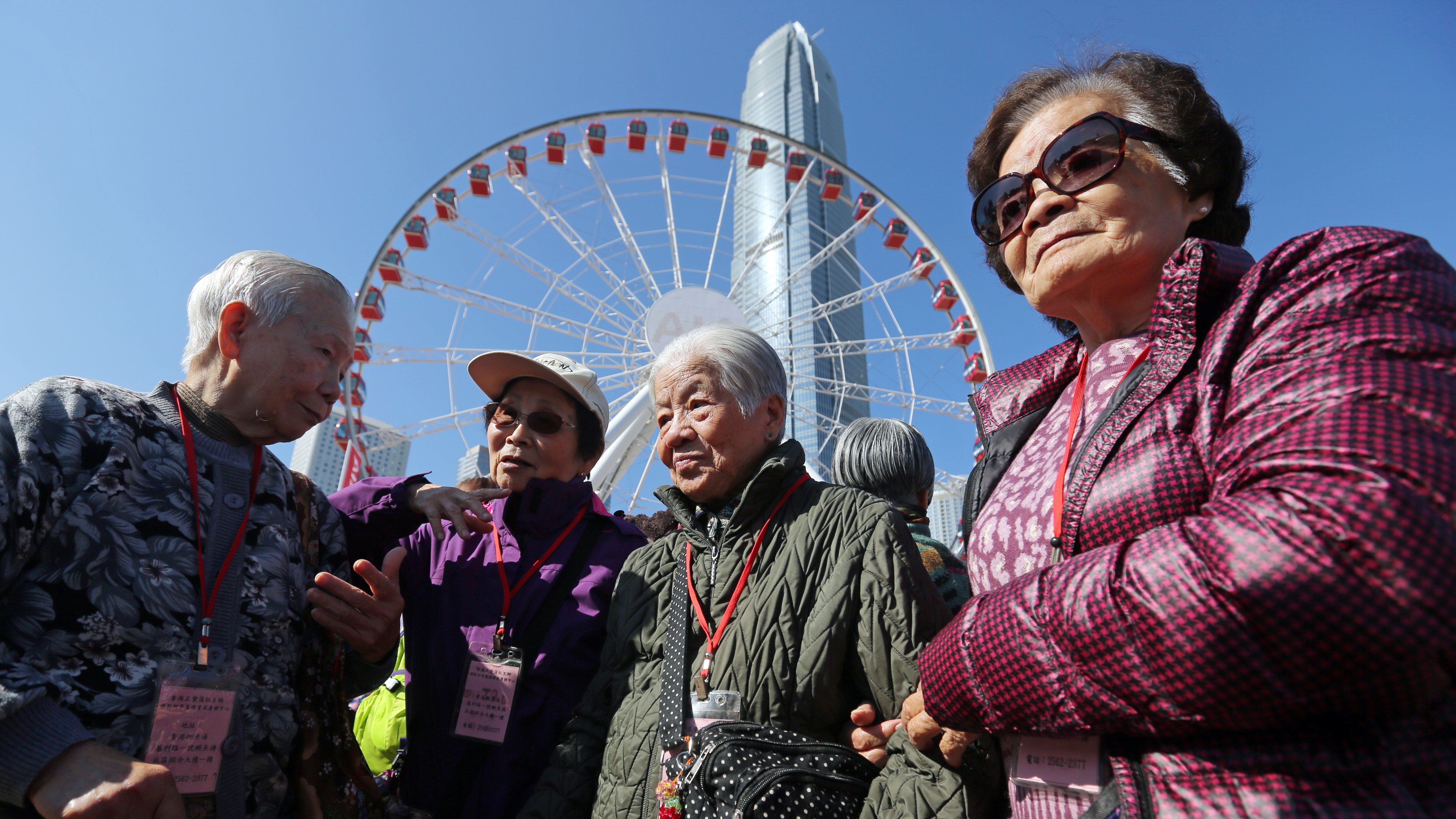 (Left to right) Chiu Wai-chan, Choi Sau-ming, Chow Fuk-far, and Li Au-ying get ready for a ride at the Observation Wheel in Central in December. Social relationships are important to keep us mentally healthy. Photo: Xiaomei Chen