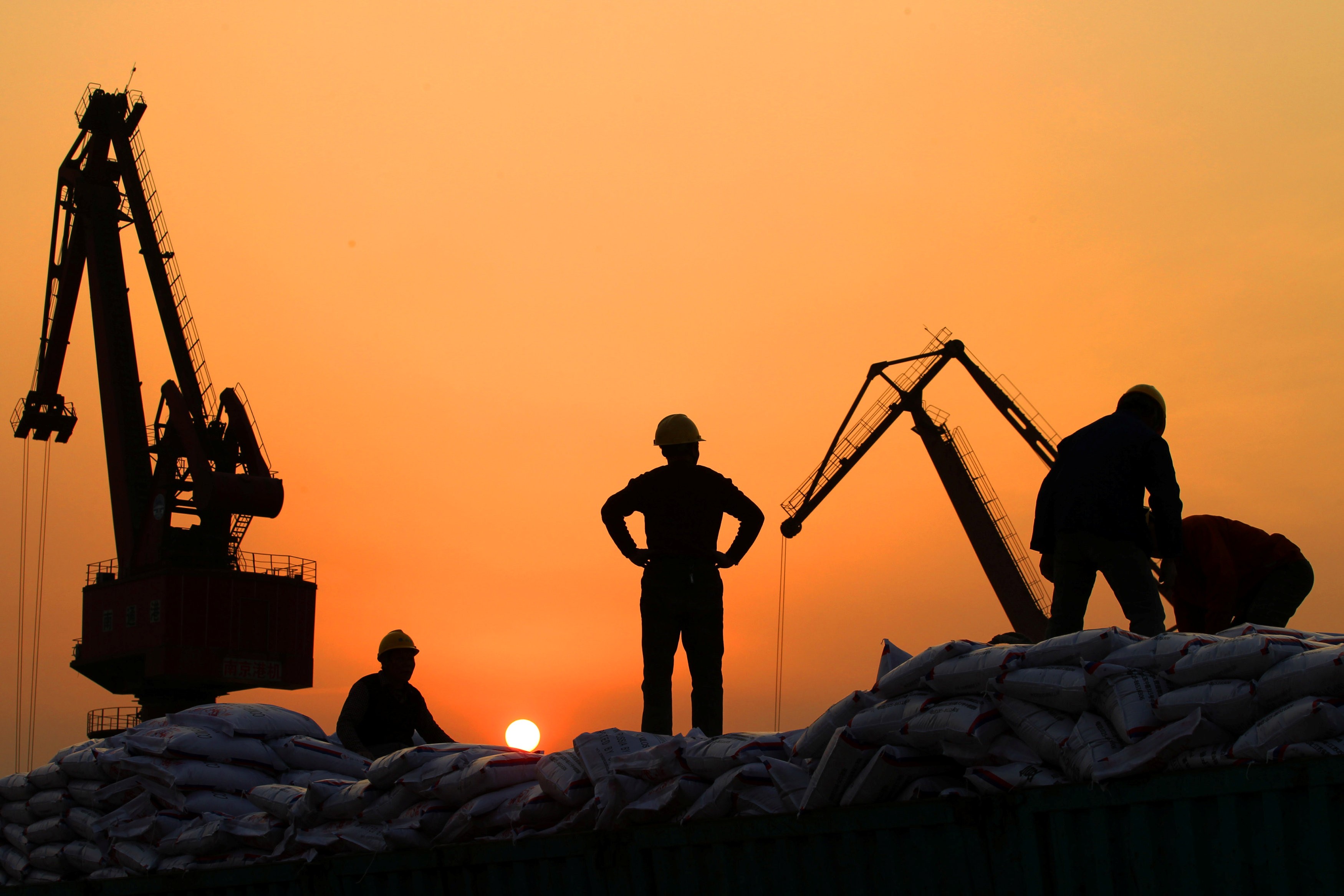 Workers load imported goods at a port in Nantong, Jiangsu province, China. Ambitious businesses and leaders in the region are busy formulating strategic plans to be involved in the ‘Belt and Road Initiative’, which will involve people in more than 70 countries around the world.
