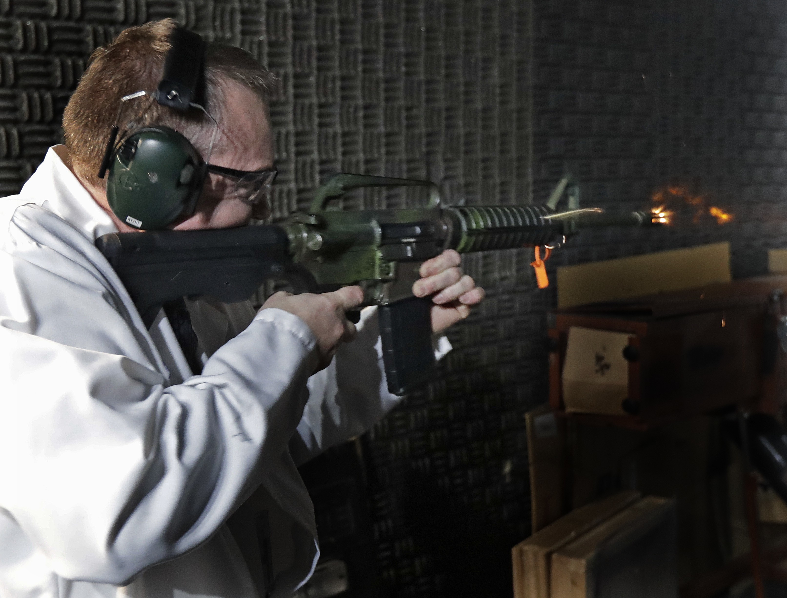 In this January 11, 2018 photo, Washington Rick Wyant, supervisor of the forensic firearms unit at the Washington state Patrol crime laboratory in Seattle, test fires a semi-automatic rifle that has been fitted with a so-called bump stock device to make it fire faster. Photo: AP