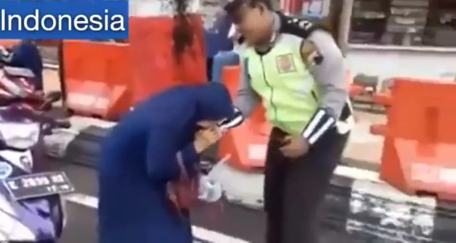 Woman stops biting the officer momentarily to scream at him before continuing to gnaw on his right hand