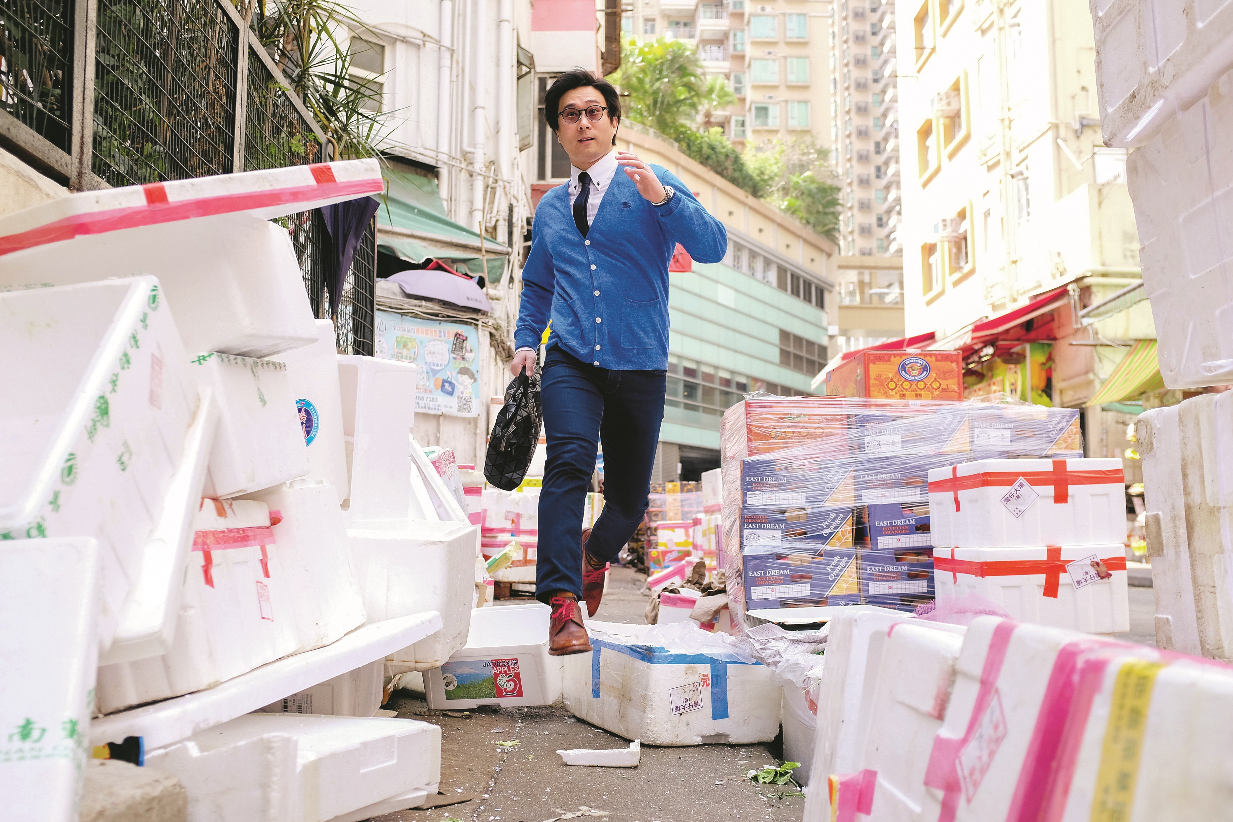 Dr Christopher See, a lecturer at HKU, demonstrating his daily exercise workout which involves dodging pedestrians and jumping over obstacles in the Wan Chai Market on his way to work. Photo: Antony Dickson