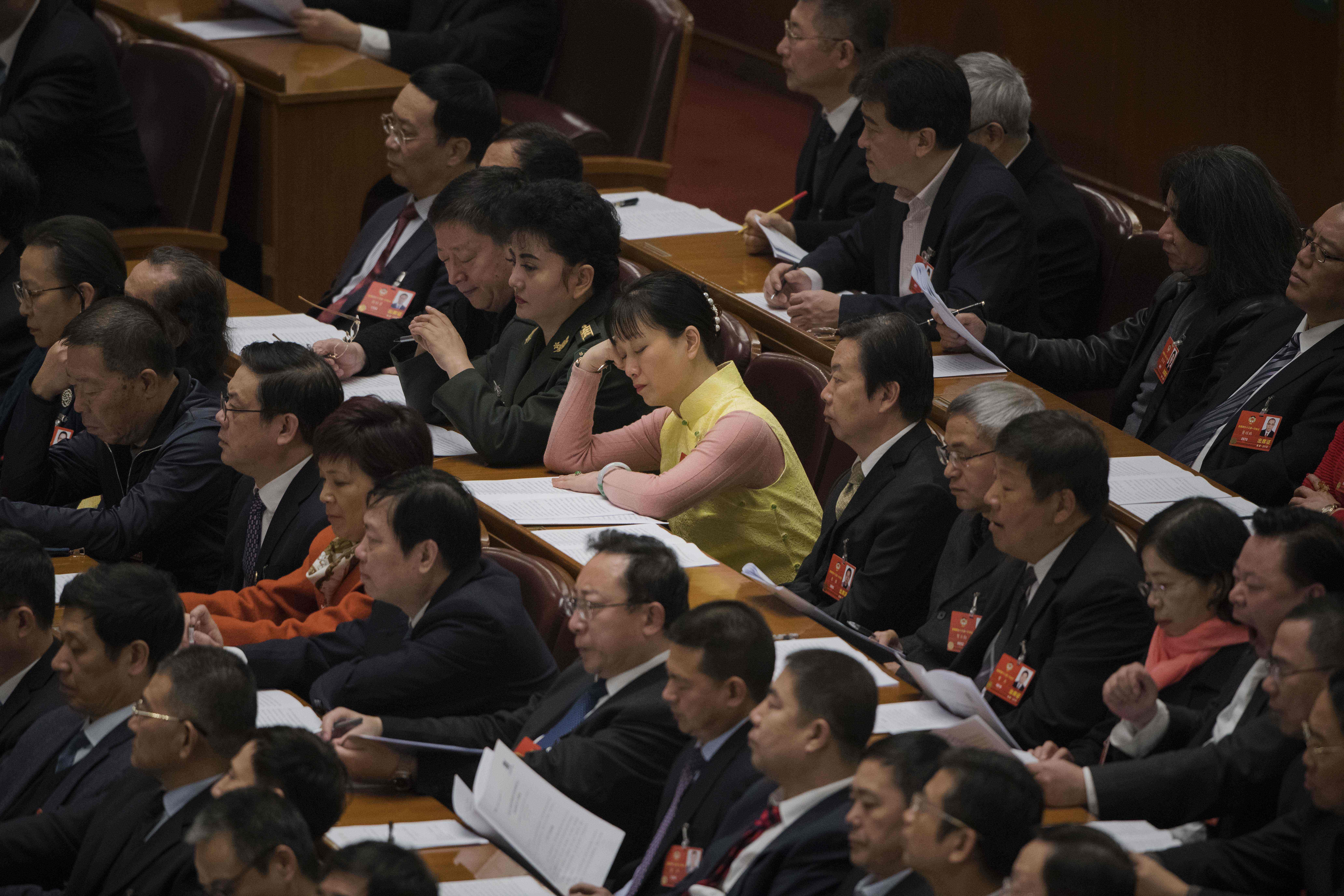 A delegate dozes off during the opening session of the CPPCC in Beijing on Saturday. Photo: AFP