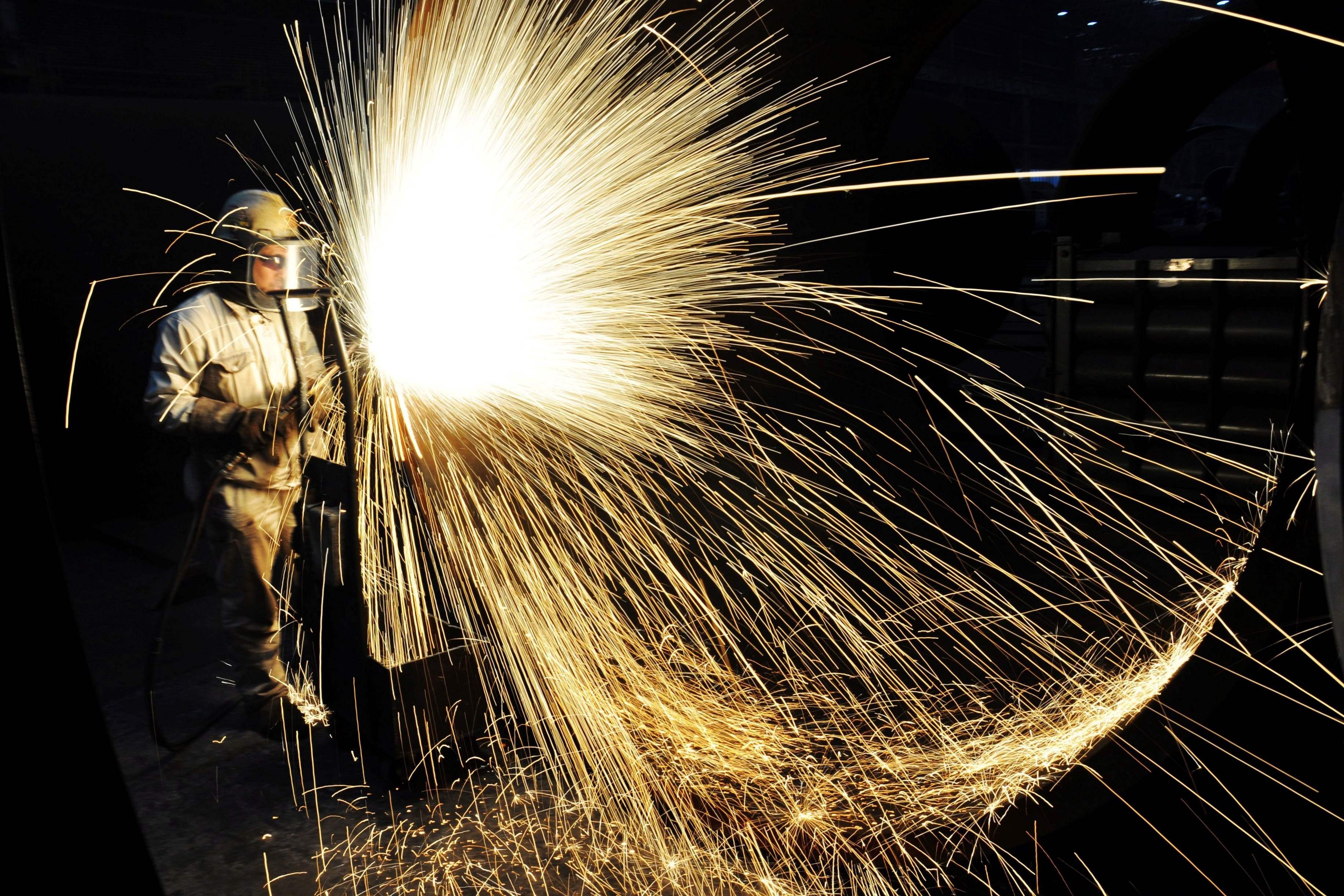 A Chinese worker cutting steel in Qingdao in China's eastern Shandong province. Despite fierce opposition from inside the White House, US President Donald Trump has confirmed punishing steel and aluminium tariffs, teeing up a potential trade war with major producers, as well as China. Photo: AFP