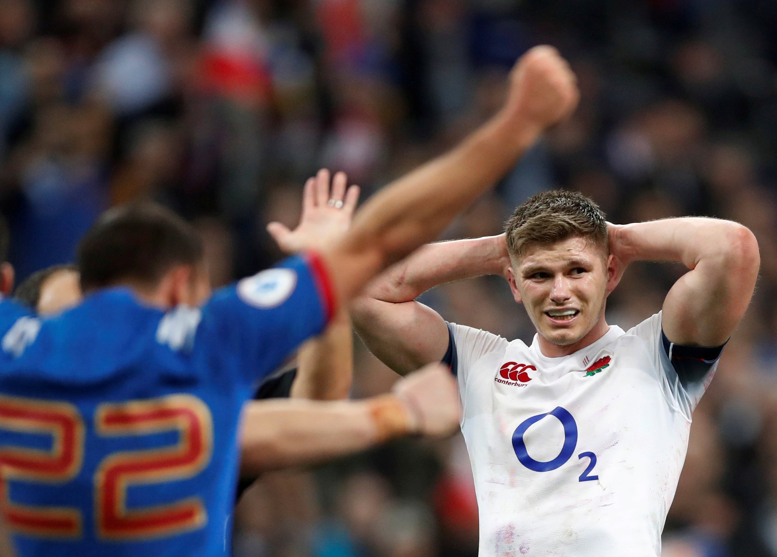 England’s Owen Farrell looks dejected as France celebrate victory after the match. Photo: Reuters