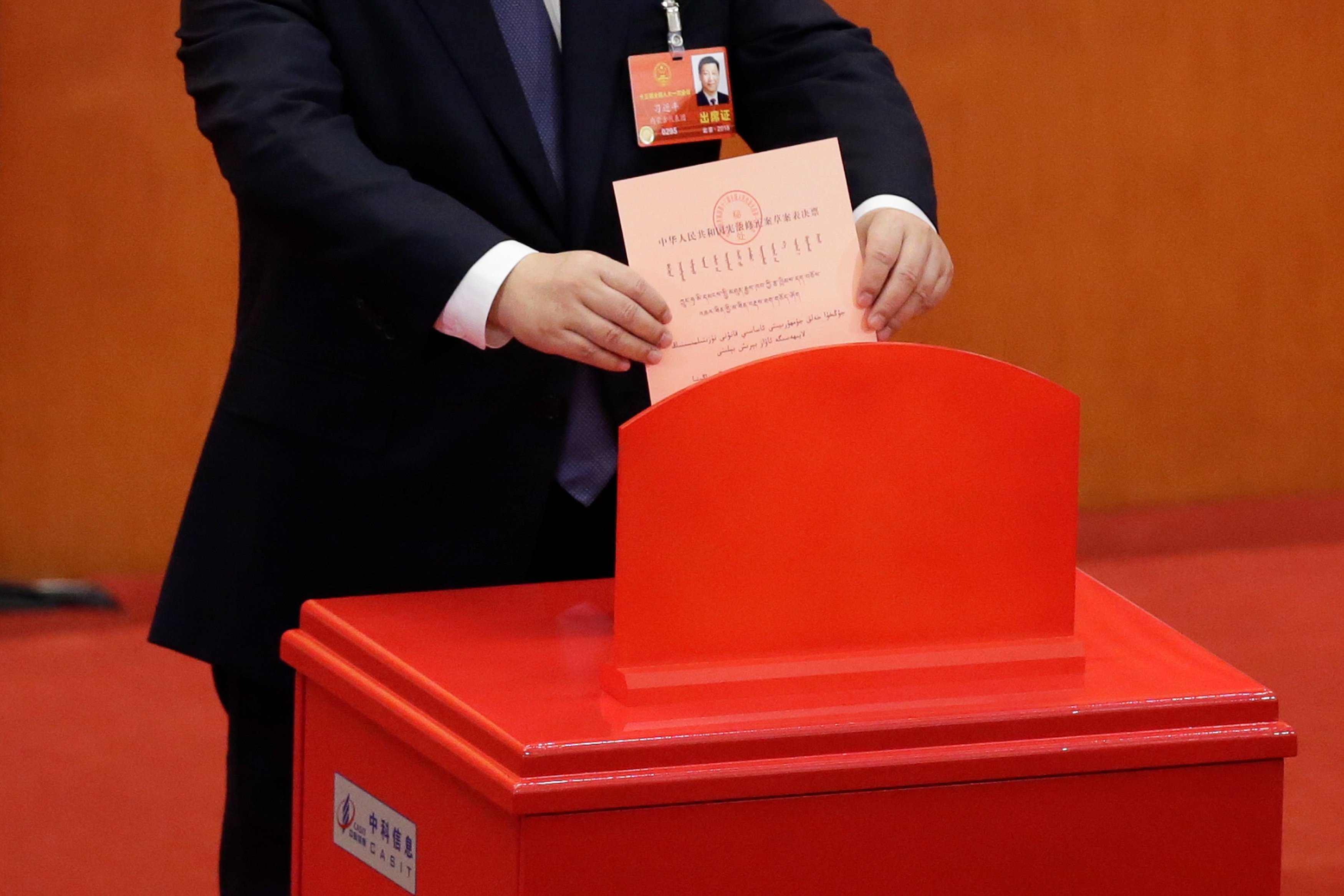 Chinese President Xi Jinping drops his ballot during a vote on a constitutional amendment lifting presidential term limits, at the third plenary session of the National People's Congress at the Great Hall of the People in Beijing. Photo: Reuters