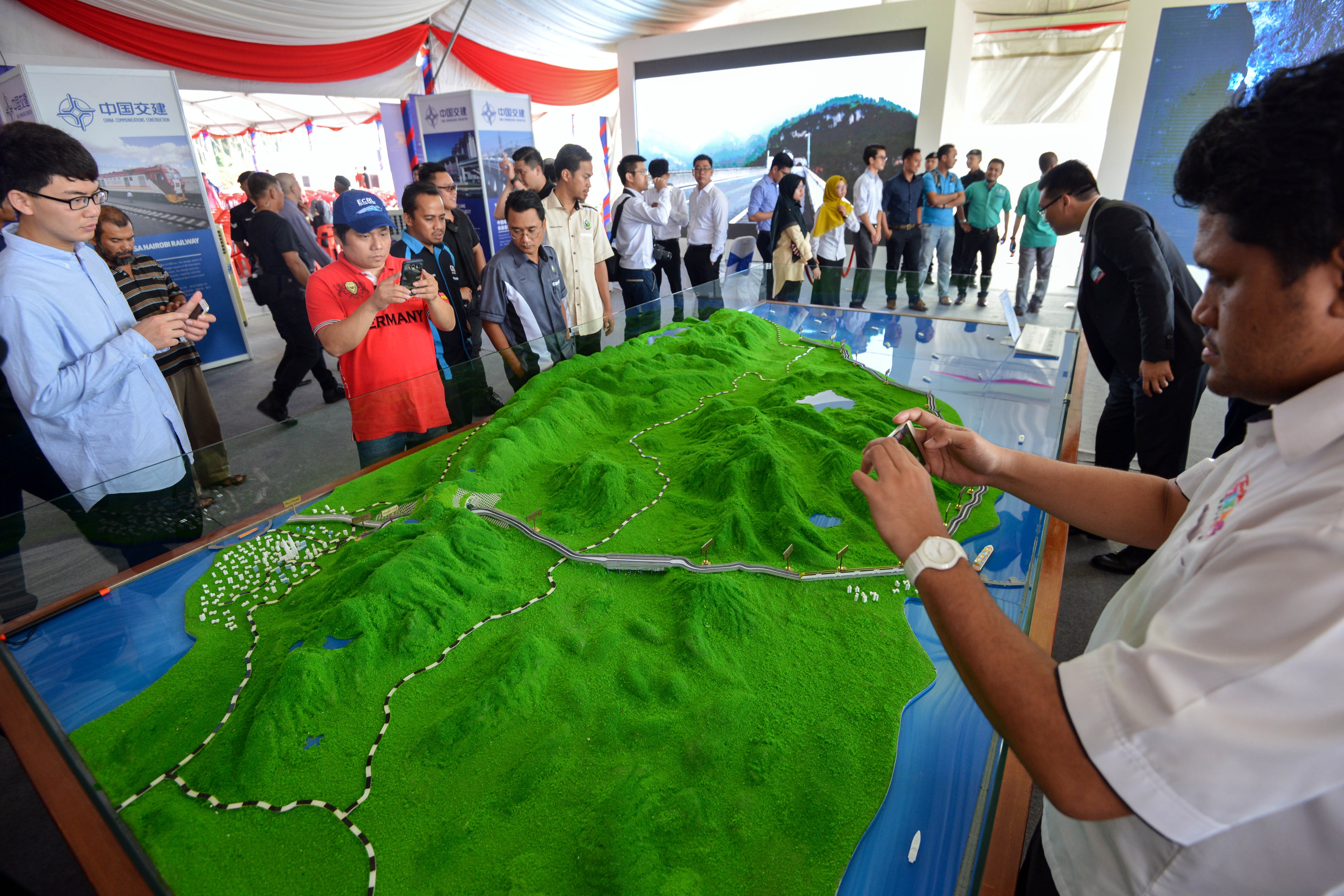People view a model of the East Coast Rail Link, a huge railway to be built by China as part of its ‘Belt and Road Initiative’, during the launch in Kuantan, Malaysia, on August 2017. Photo: Chong Voon Chung/ Xinhua