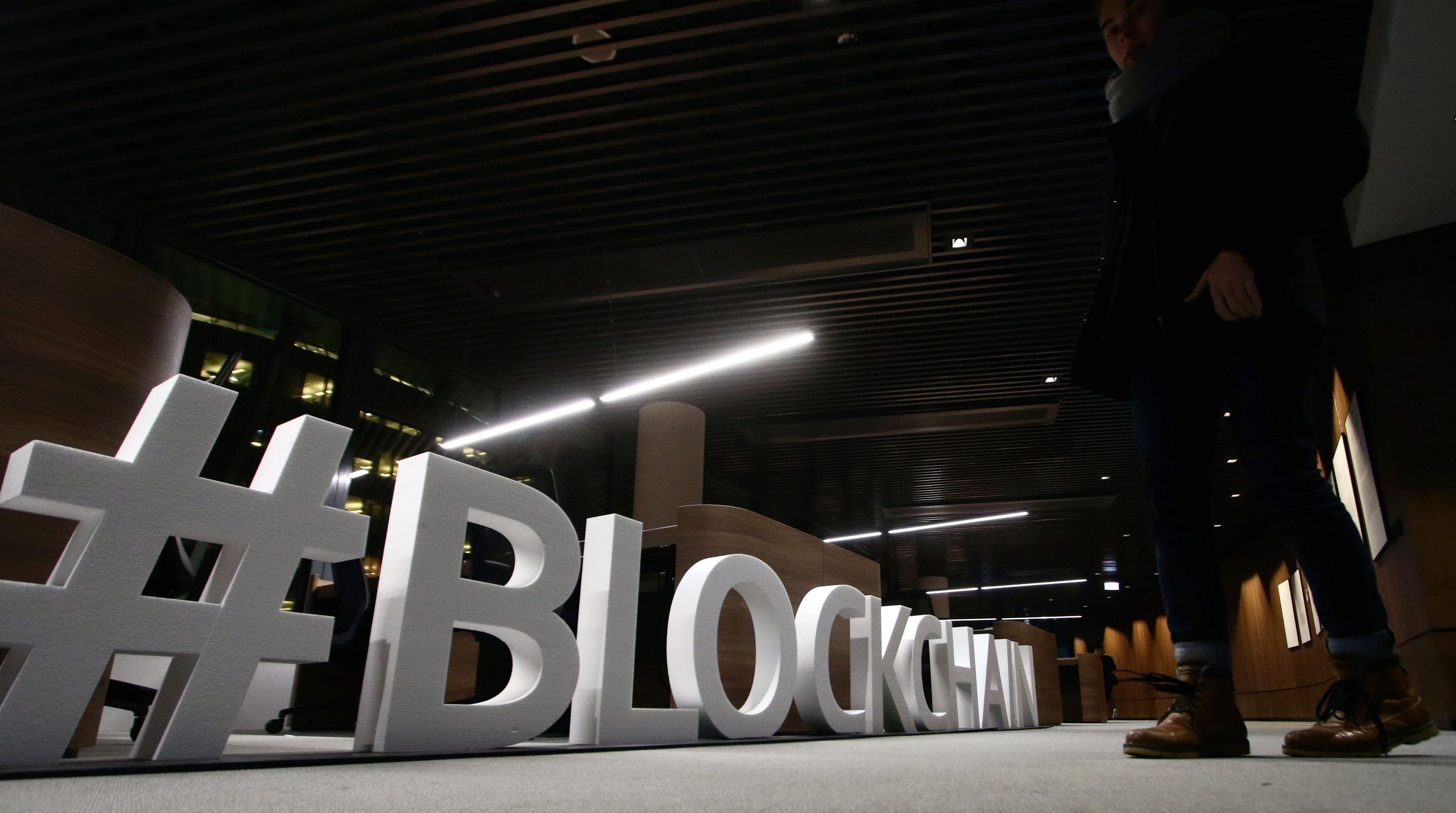 Giant letters, reading the word “blockchain” on display at the blockchain centre, which aims at boosting start-ups in Lithuania's capital Vilnius. Peter Guy argues that e-commerce development in Hong Kong is being stifled by the bureaucrats at the HKMA, who are resisting any opportunity and perceived risk to innovate. Photo: AFP
