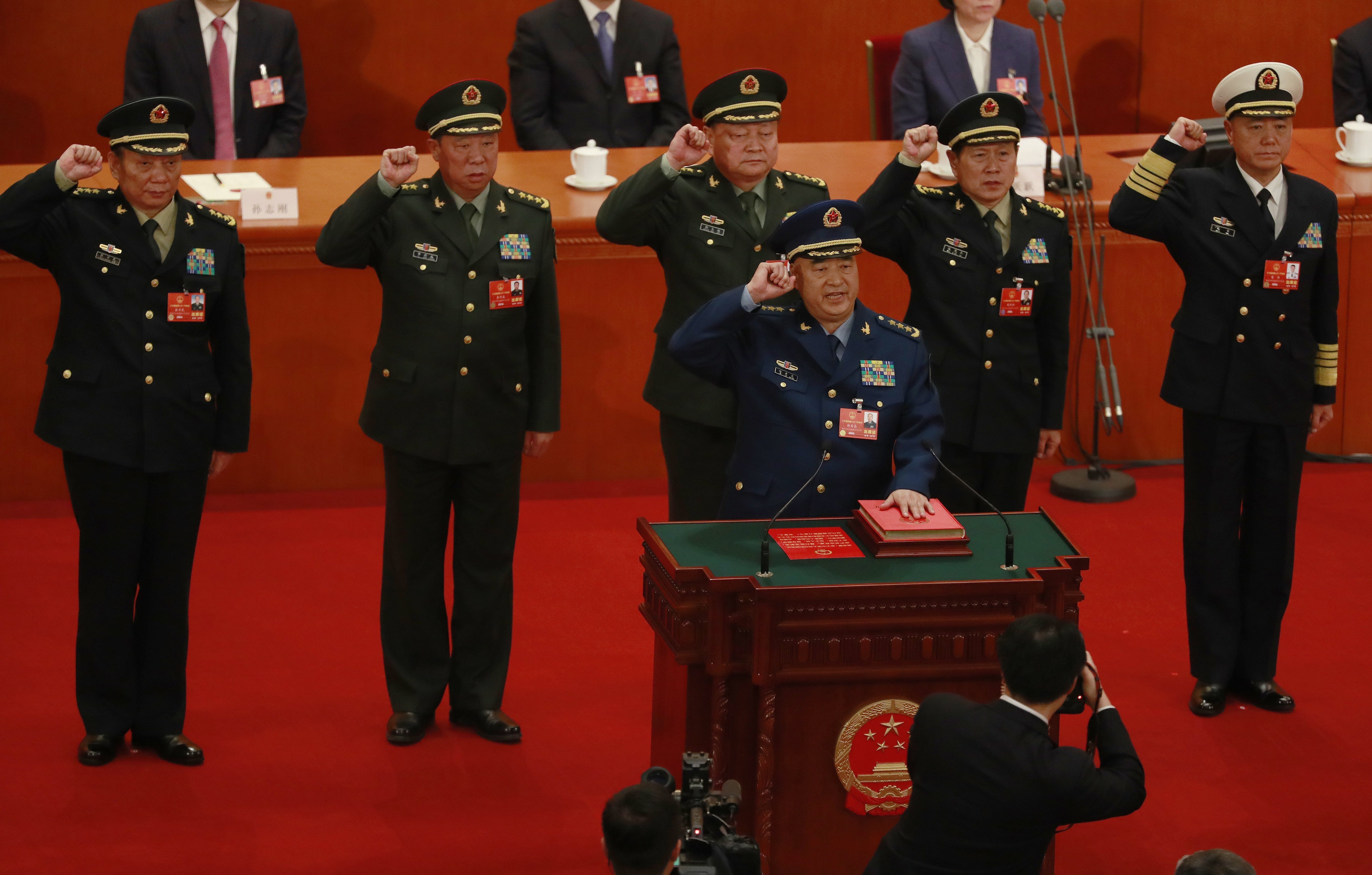 Newly appointed vice-chairman of the Central Military Commission Xu Qiliang (at podium) leads the military oath-taking ceremony at the National People’s Congress in Beijing on Sunday. Also pictured are CMC vice-chairman Zhang Youxia (back row, centre) and regular members (from left) Zhang Shengmin, Li Zuocheng, Wei Fenghe and Miao Hua. Photo: EPA-EFE