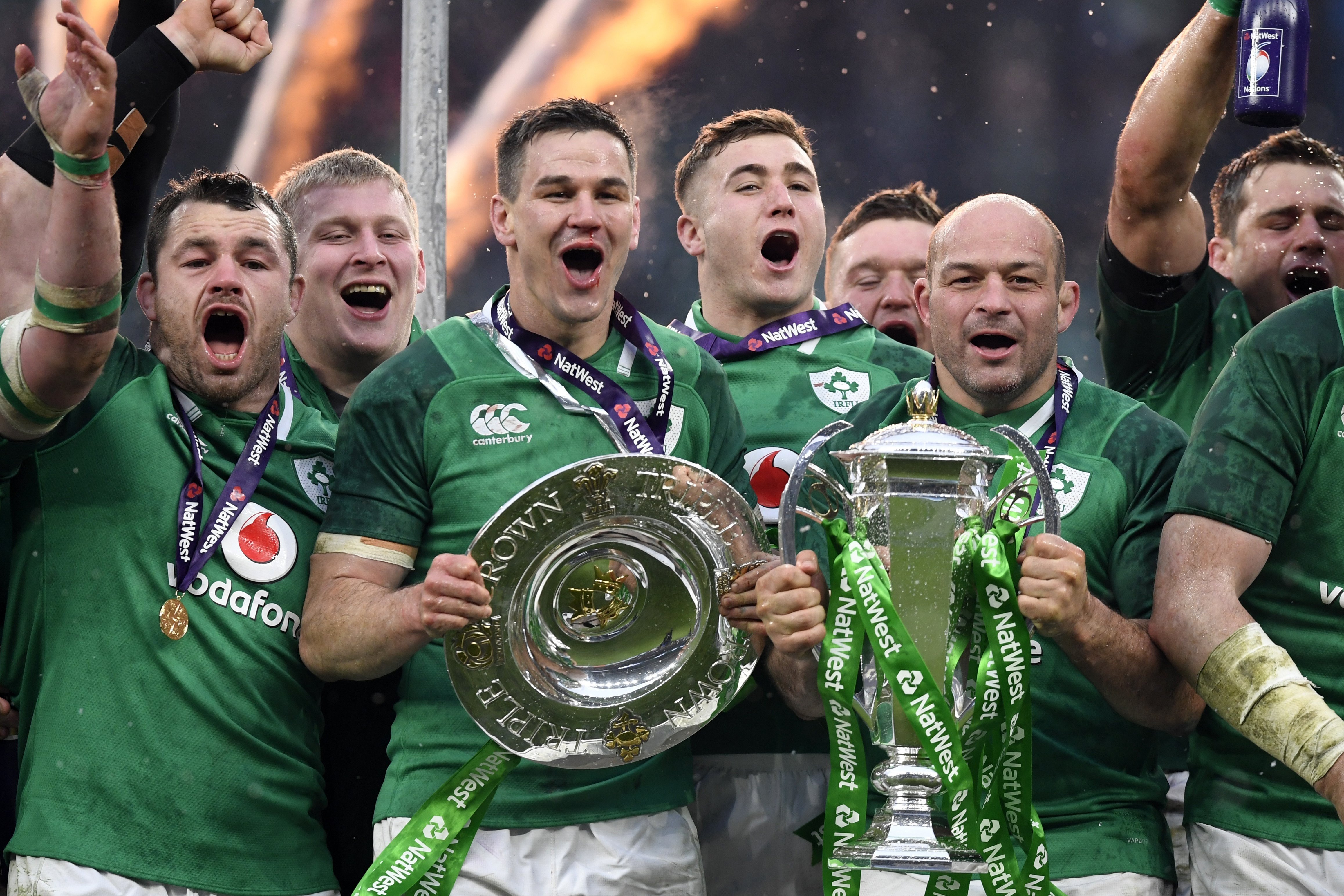Ireland’s Johnny Sexton (centre left) and captain Rory Best (right) celebrate with the Six Nations trophy and Triple Crown Trophy after Ireland beat England. Photo: EPA