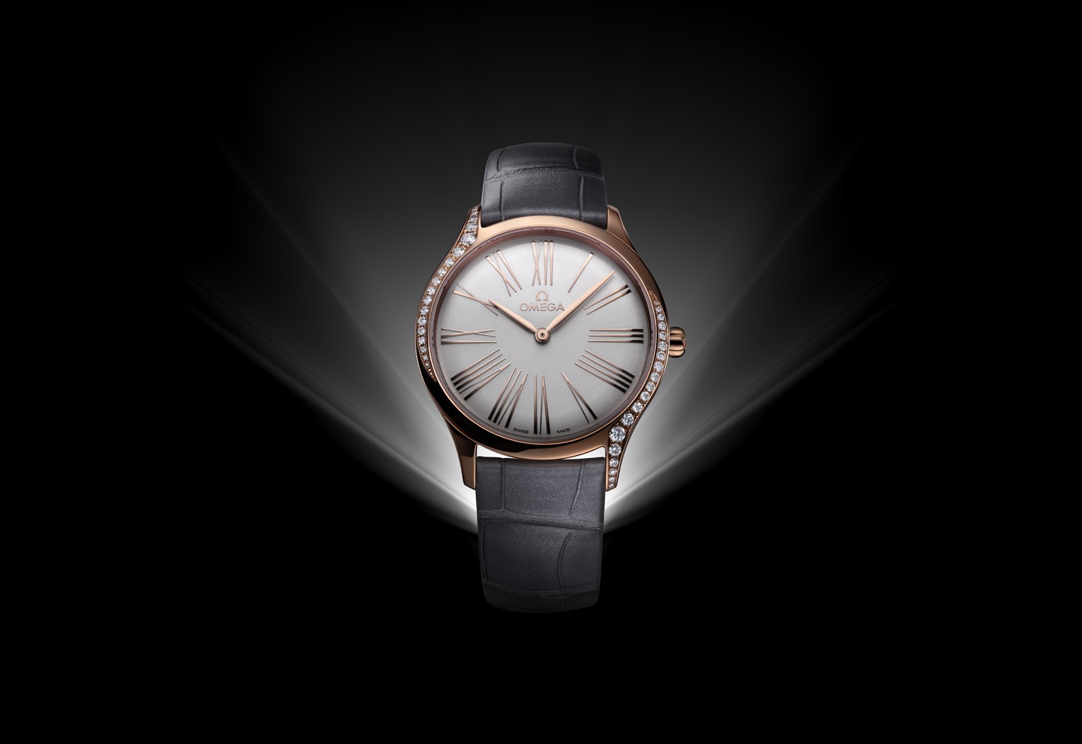 Omega’s De Ville Trésor 36 mm comes in 18ct Sedna gold with a lacquered opaline silver dial and grey leather straps.