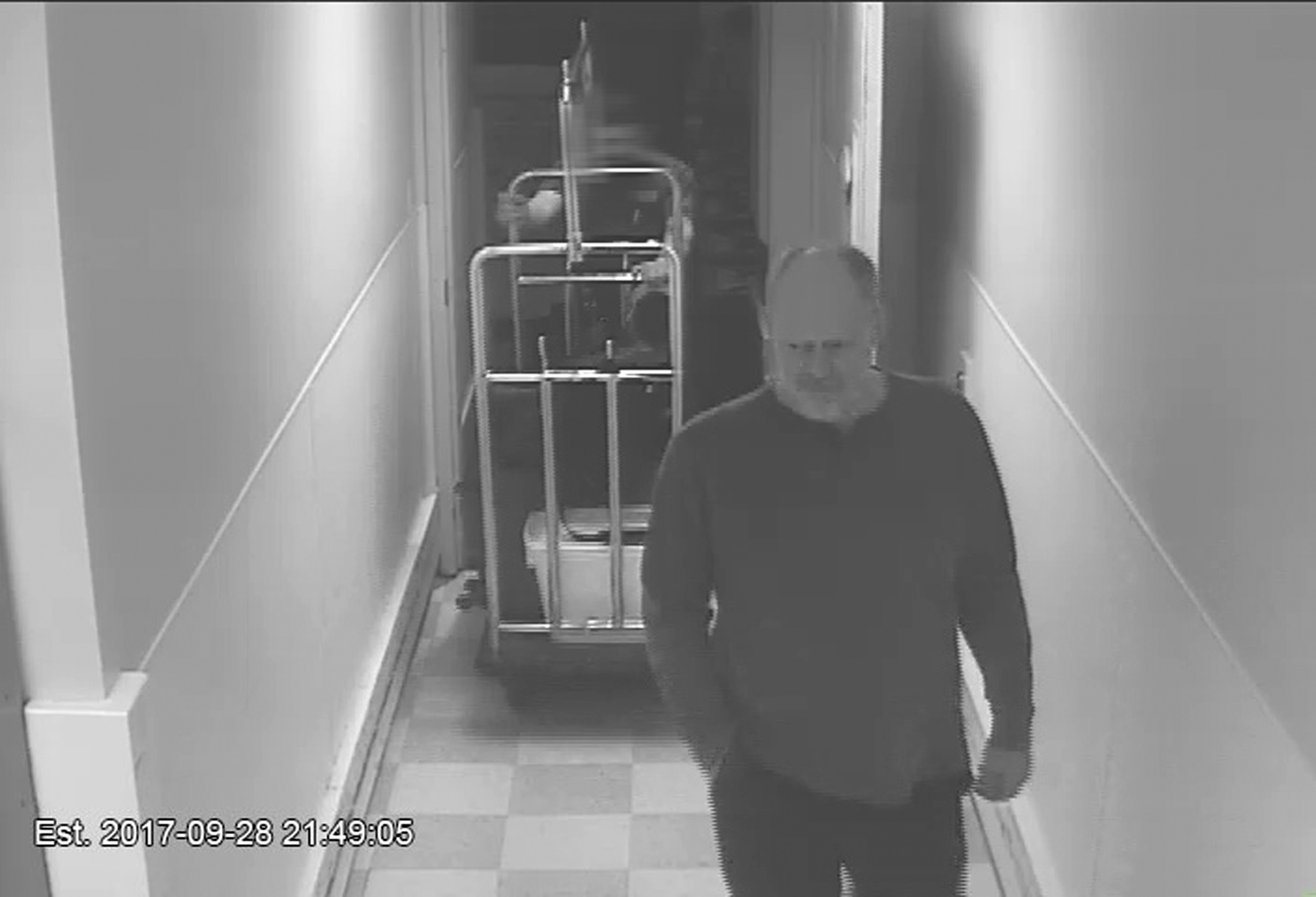 In this September28, 2017, security camera image released by MGM Resorts, Stephen Paddock is followed by a bellman in a hallway, at the Mandalay Bay hotel in Las Vegas. Photo: AP