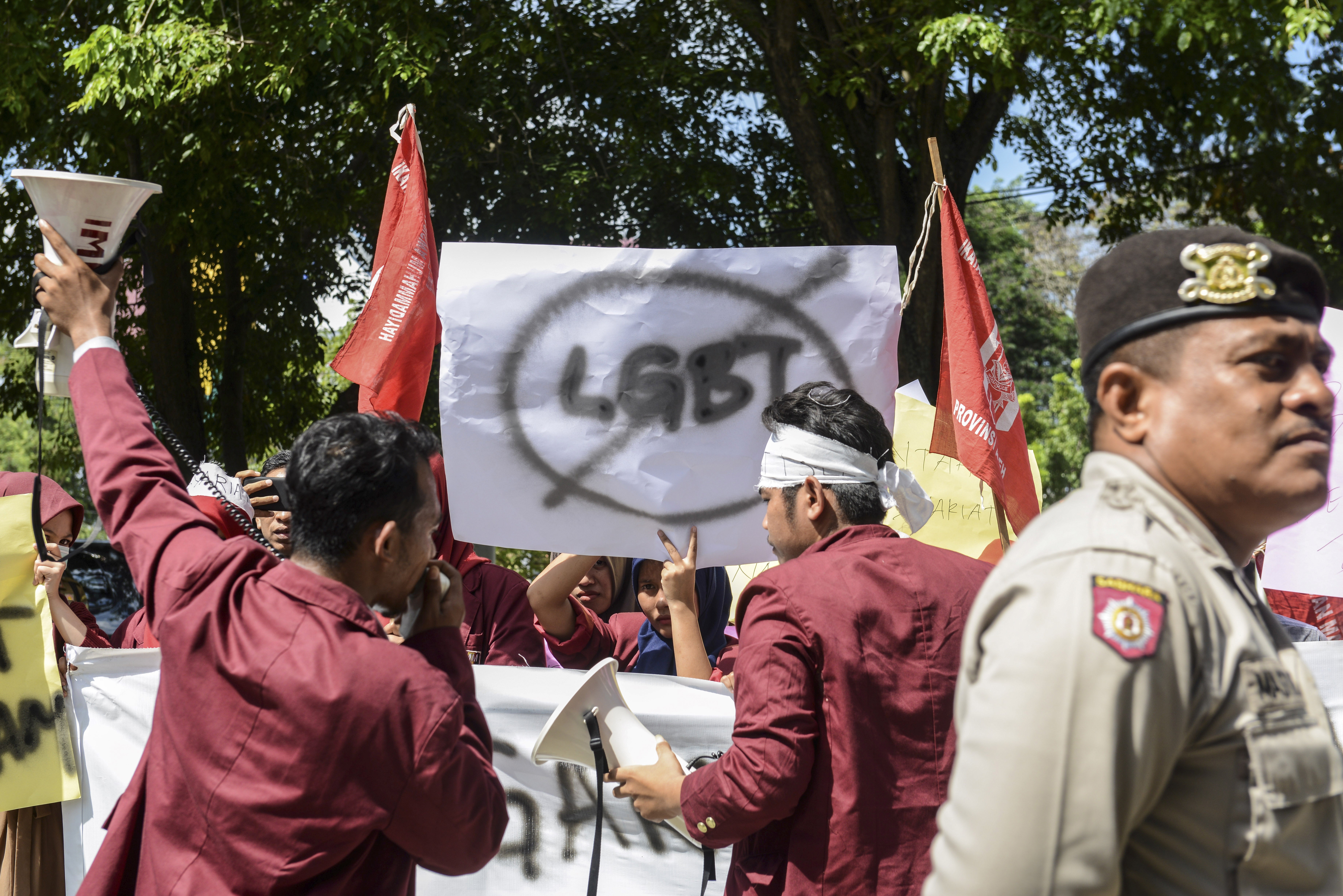 A group of Muslim protesters march with banners against the lesbian, gay, bisexual and transgender community in Banda Aceh in 2017. Photo: AFP