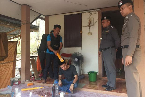 Murder suspect Makhata Seesai, 38, shows how he beat a 63-year-old monk to death with a large yellow candle in a fit of anger at a temple in Phitsanulok after they argued over a gambling debt. Photo: Chinnawat Singha/Bangkok Post