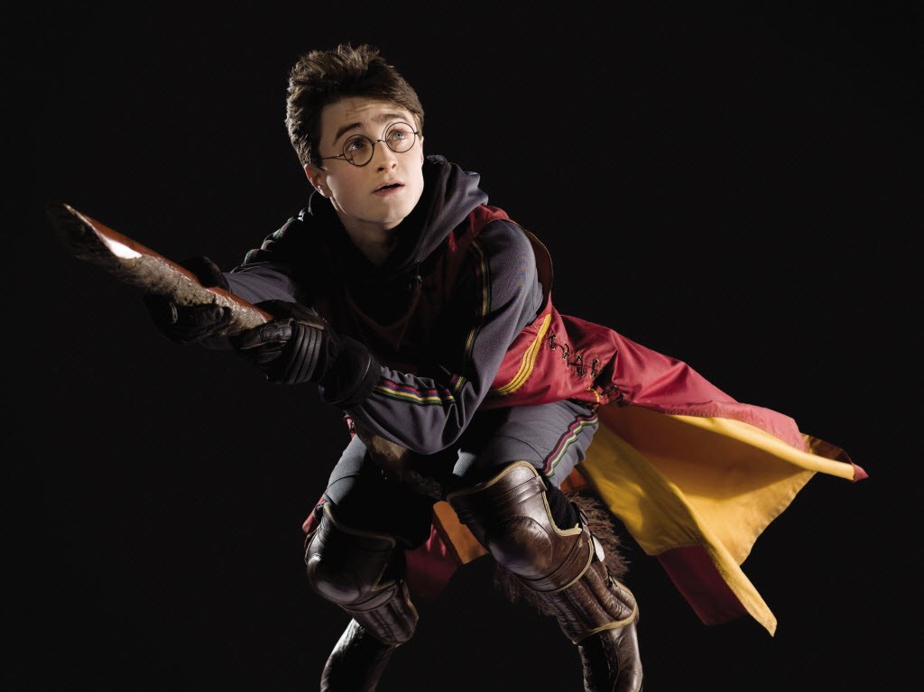 Daniel Radcliffe as Harry Potter on a broomstick.