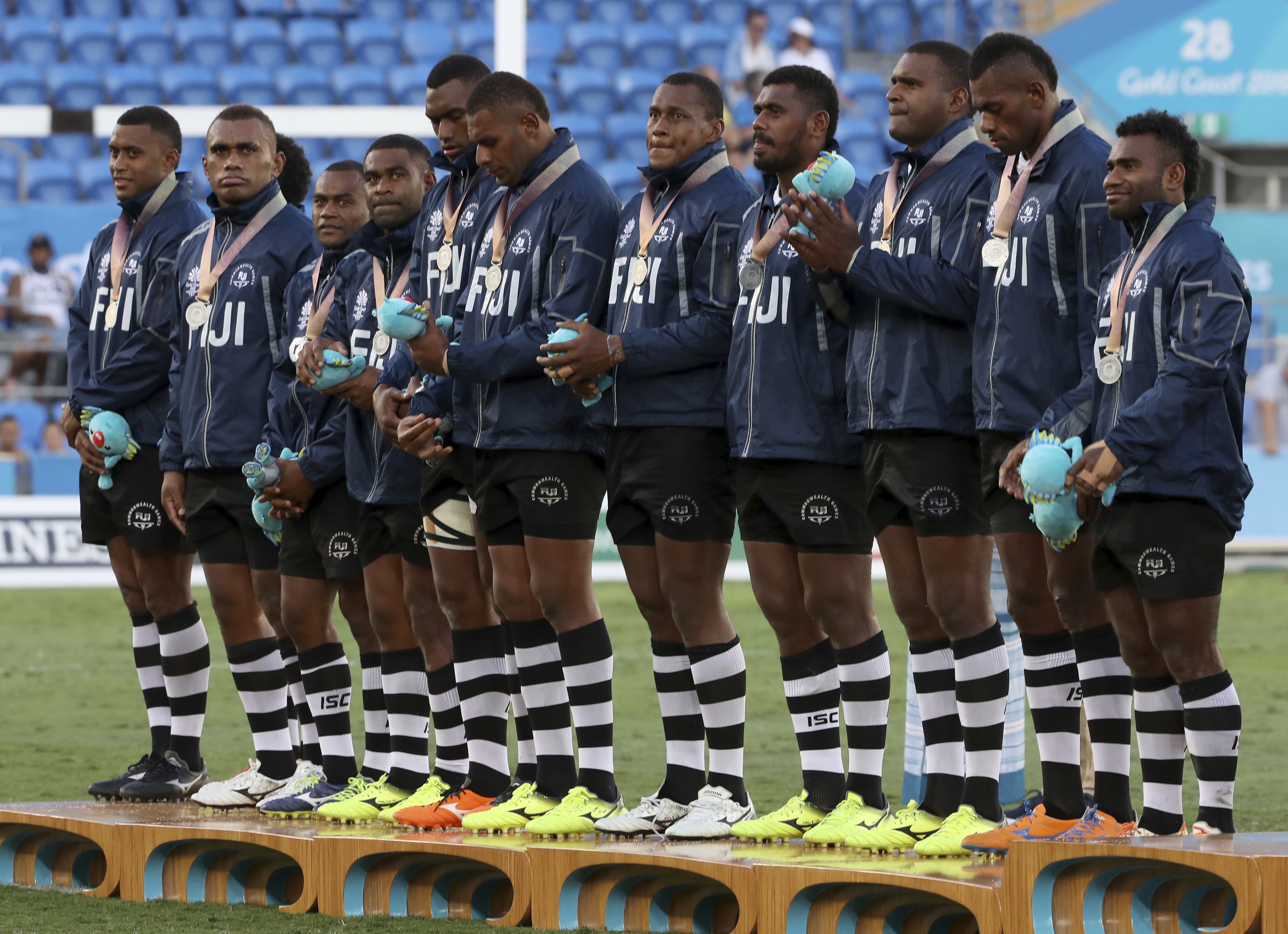 The Fiji men’s rugby sevens team on the podium after taking the silver medal at Robina Stadium. Photo: AP