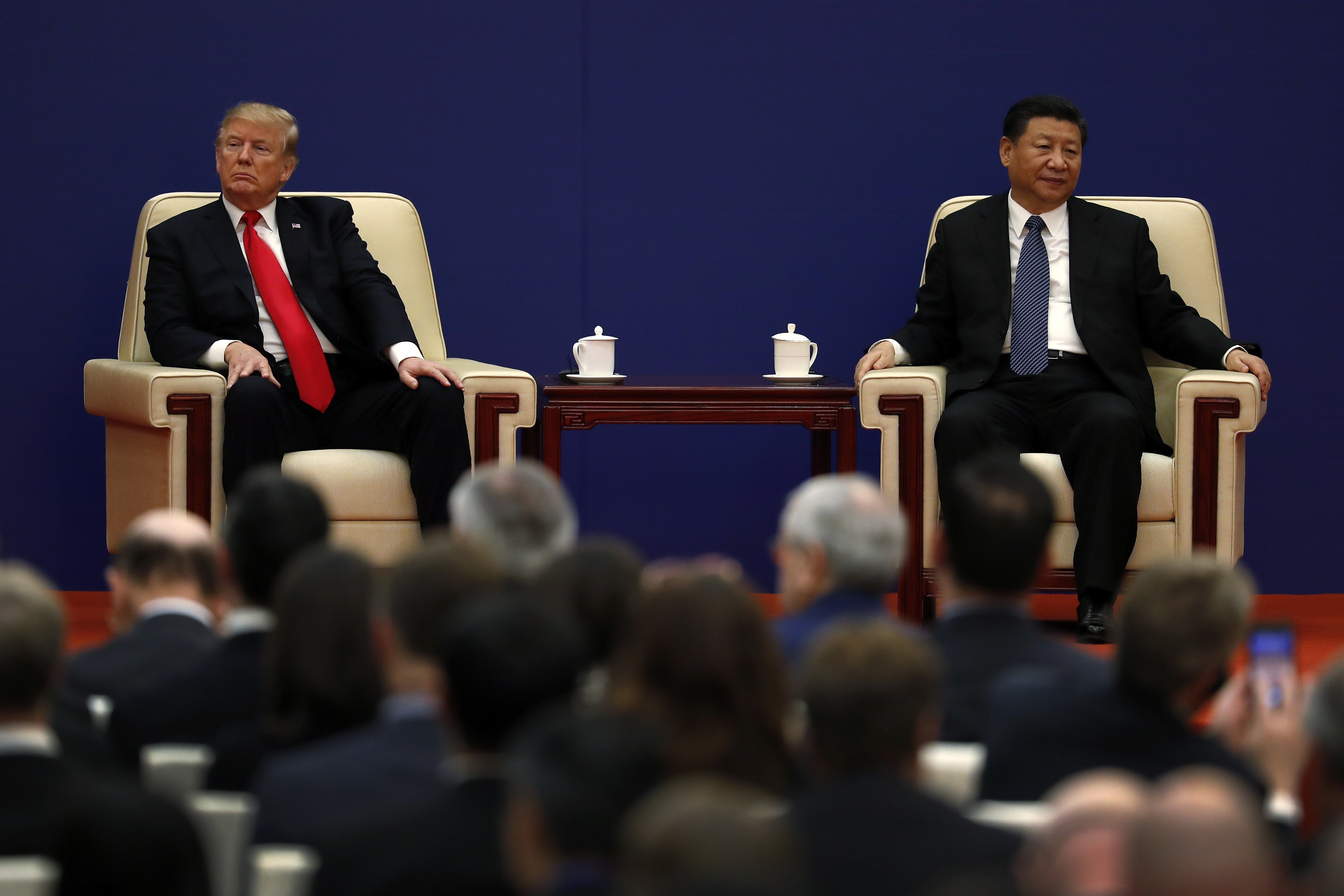US President Donald Trump (left) sits next to Chinese President Xi Jinping during a business event at the Great Hall of the People in Beijing in November 2017. Ties between the two countries have been strained since the start of the year. Photo: AP 