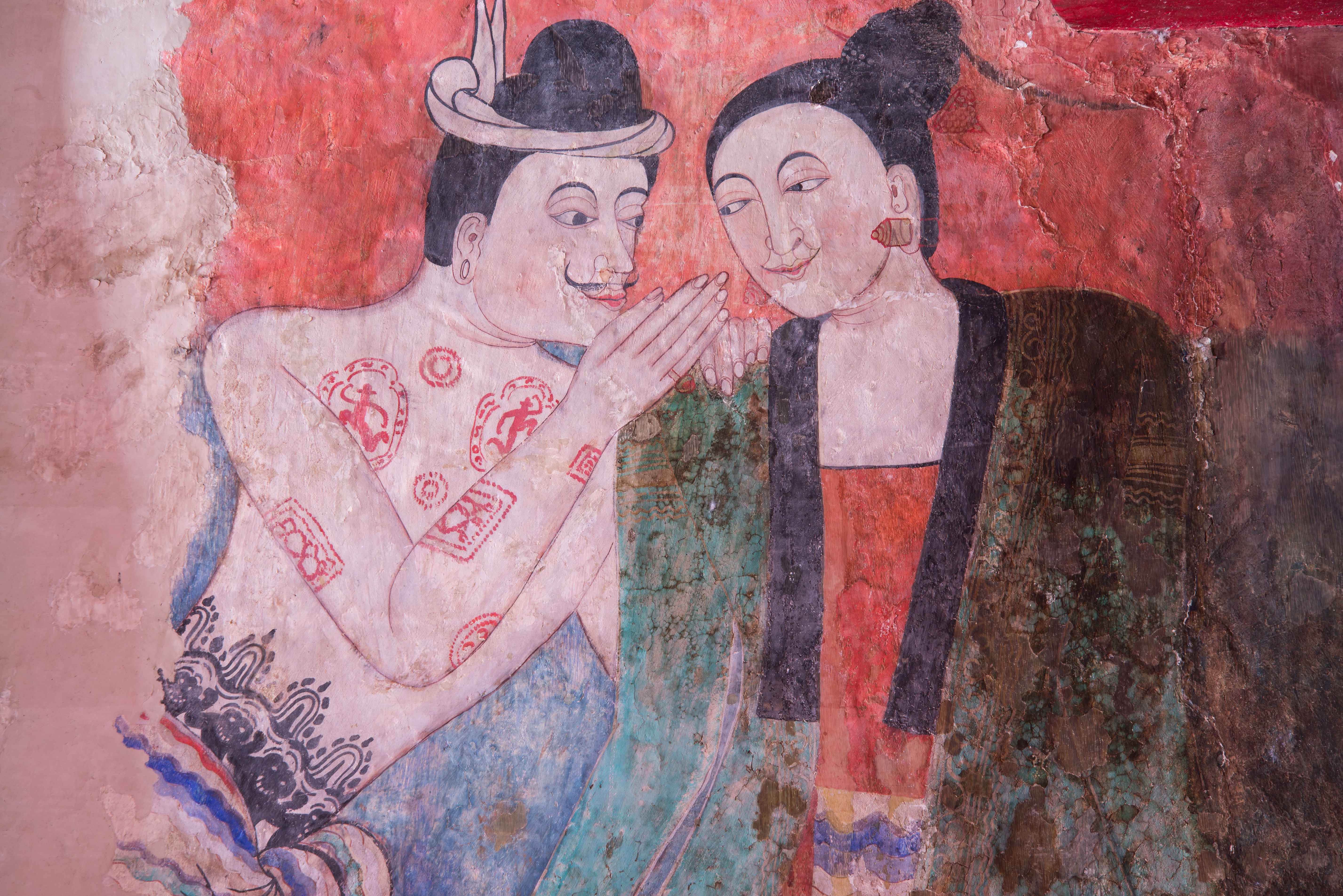 An ancient mural painting of a man whispering to a woman at Wat Phumin, a famous temple in Nan province,Thailand. Buddhists believed sex was originally a product of something negative, namely human craving. Photo: Shutterstock