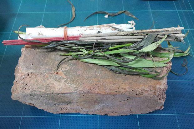 This stolen ancient brick was sent back to the office of the Ayutthaya Historical Park, together with flowers, candles, joss sticks and a letter of apology saying the sender had mysteriously fallen sick. Photo: Sunthorn Pongpao