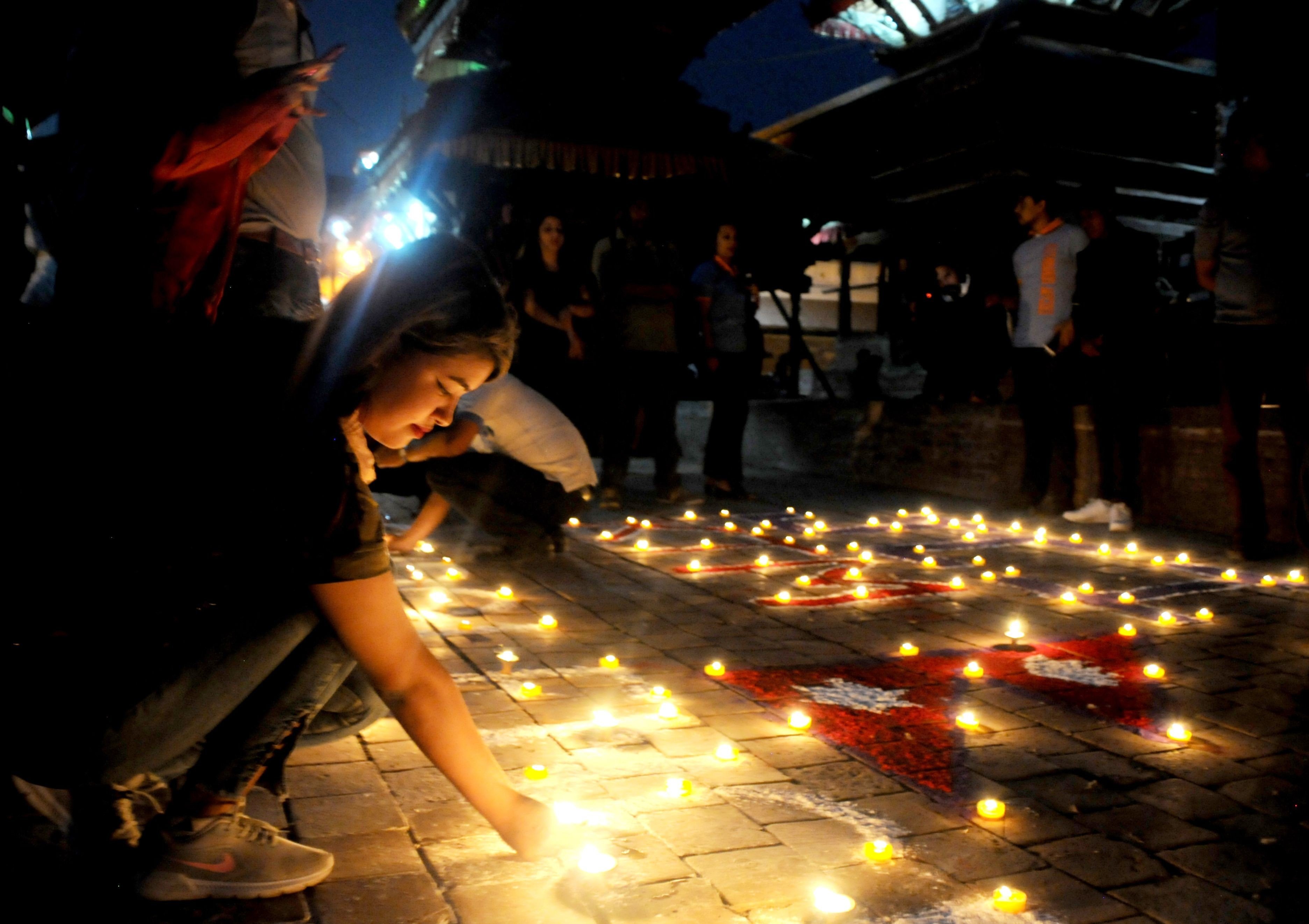 Kathmandu residents take part in a vigil on Wednesday marking the third anniversary of the earthquake that struck Nepal on April 25, 2015, killing almost 9,000 people. Photo: Agence France-Presse
