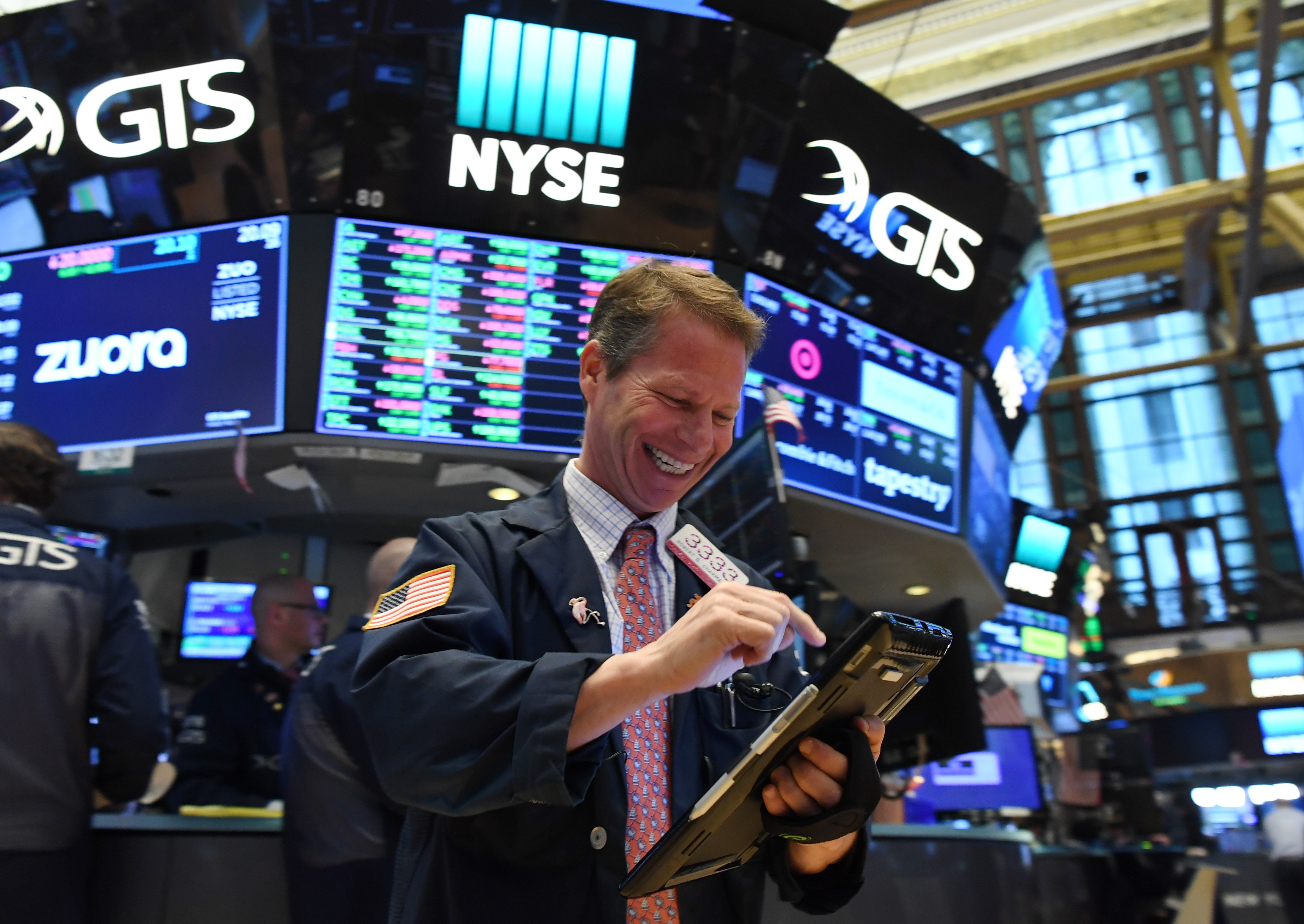A trader at the New York Stock Exchange smiles as US stocks close higher on April 12. Stocks have enjoyed a bull run under the Trump administration and corporate stock buy-backs have been the major source of demand for American equities. Photo: Xinhua