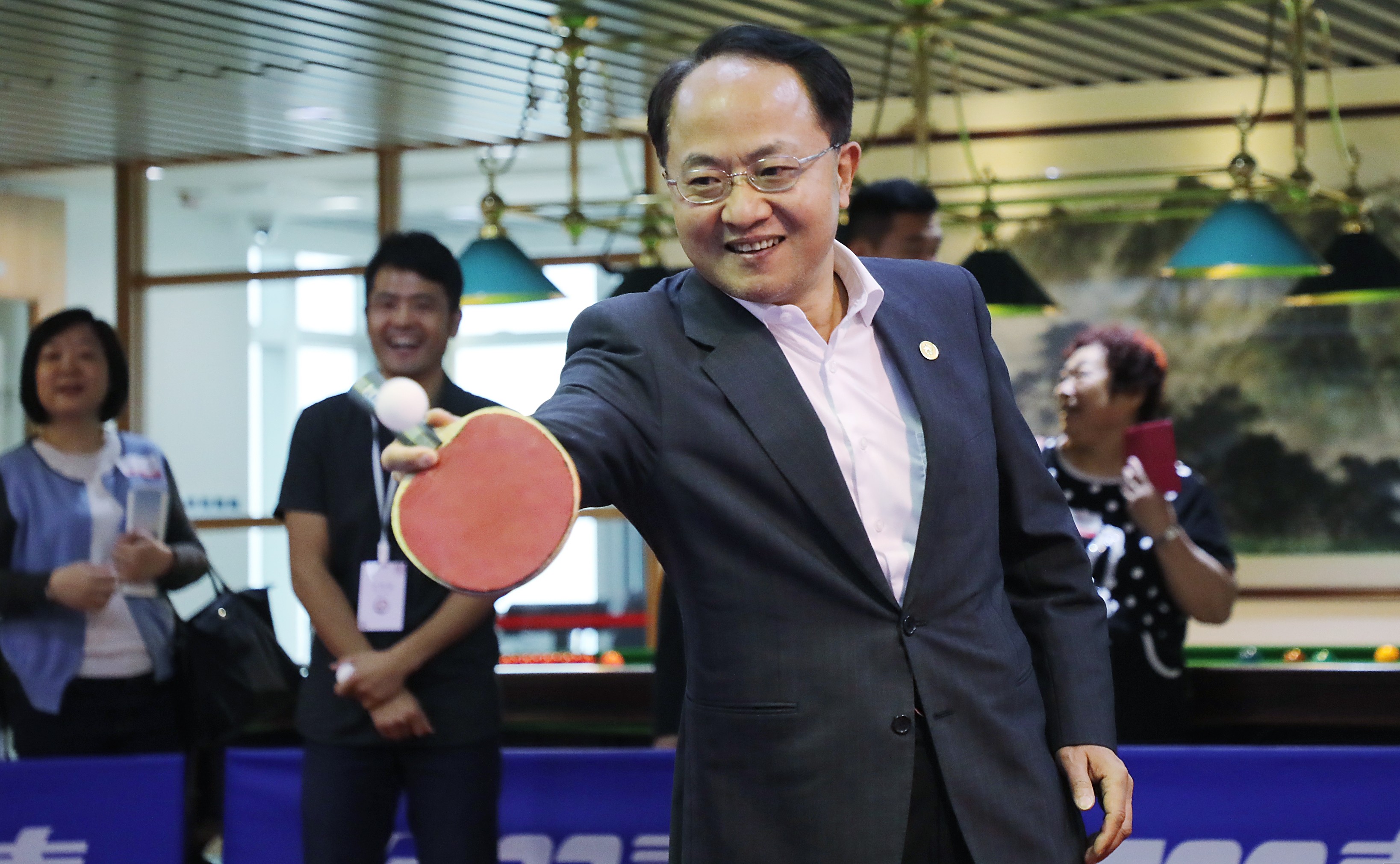 Wang Zhimin, head of the central government’s liaison office in Hong Kong, plays table tennis during the office’s open day on April 28. Wang has invited the city’s pan-democratic legislators to visit his office in Western. Photo: Edward Wong 