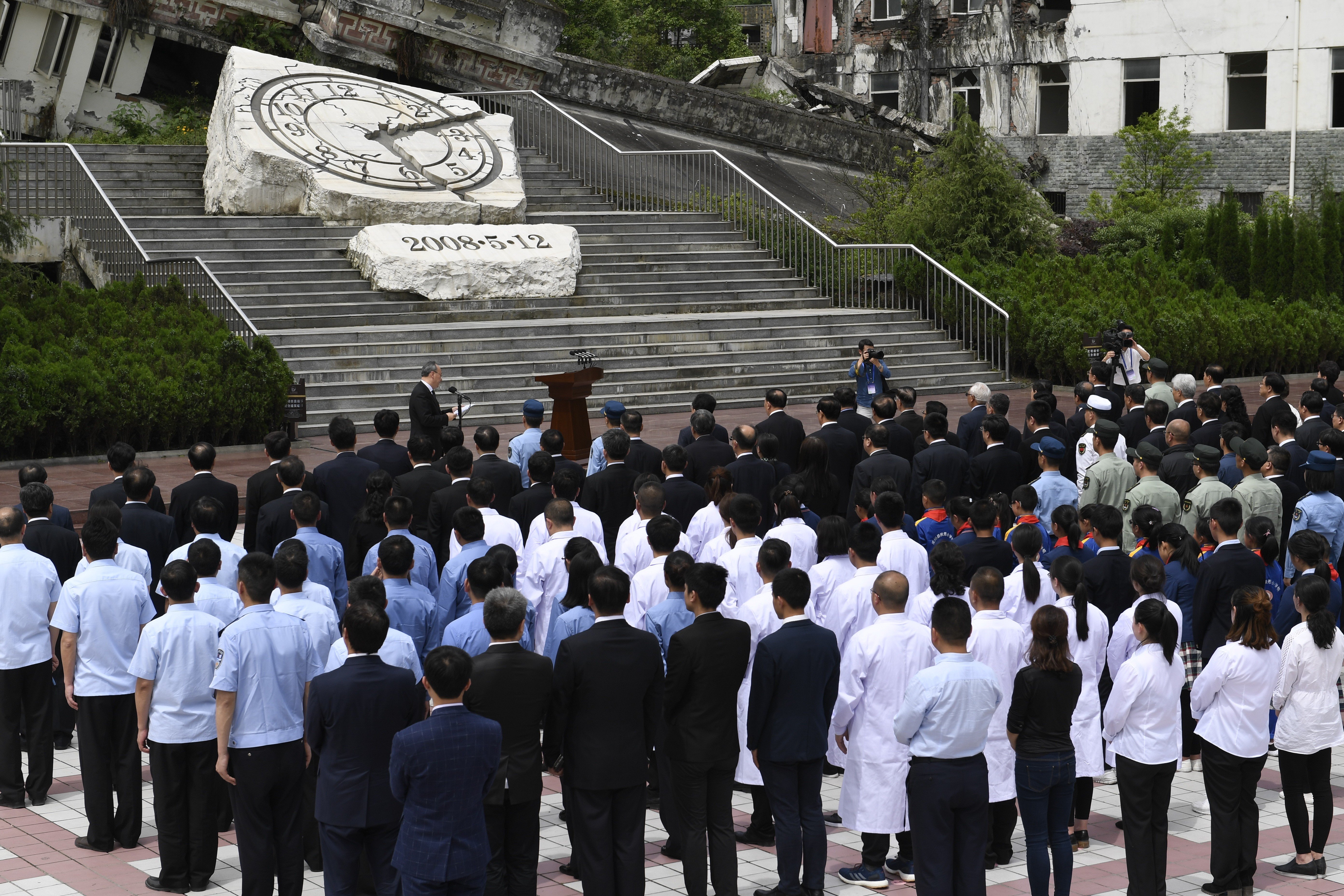 People gathered on Saturday at the site of the ruined Xuankou Middle School for a ceremony to mark the 10th anniversary of the Sichuan earthquake. Photo: Xinhua