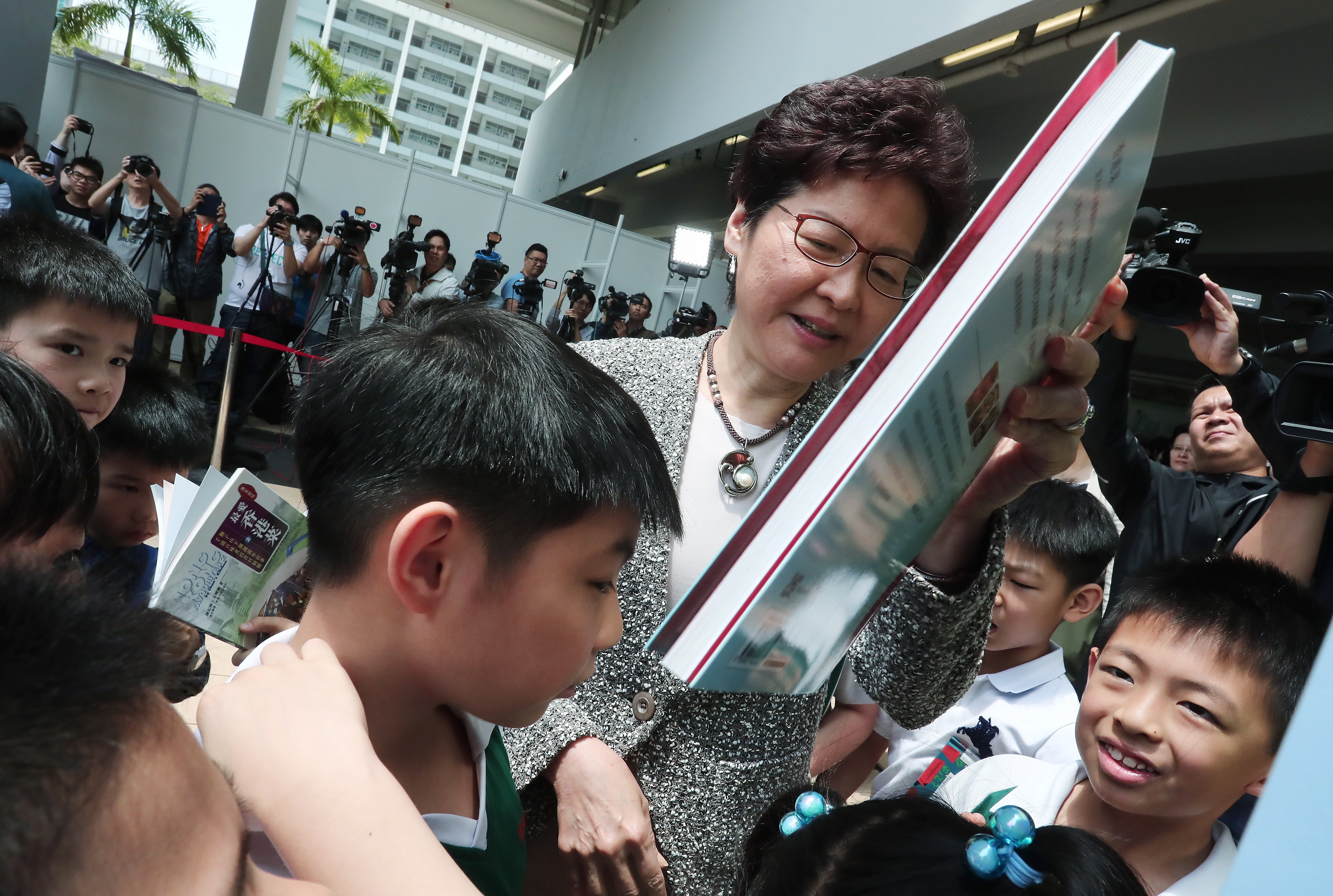 Chief Executive Carrie Lam Cheng Yuet-ngor tours the Leisure and Cultural Services Department’s “My Pop-up Library”, after the opening ceremony for the 2018 World Book Day, at a school in Sham Shui Po on April 21. Photo: Jonathan Wong