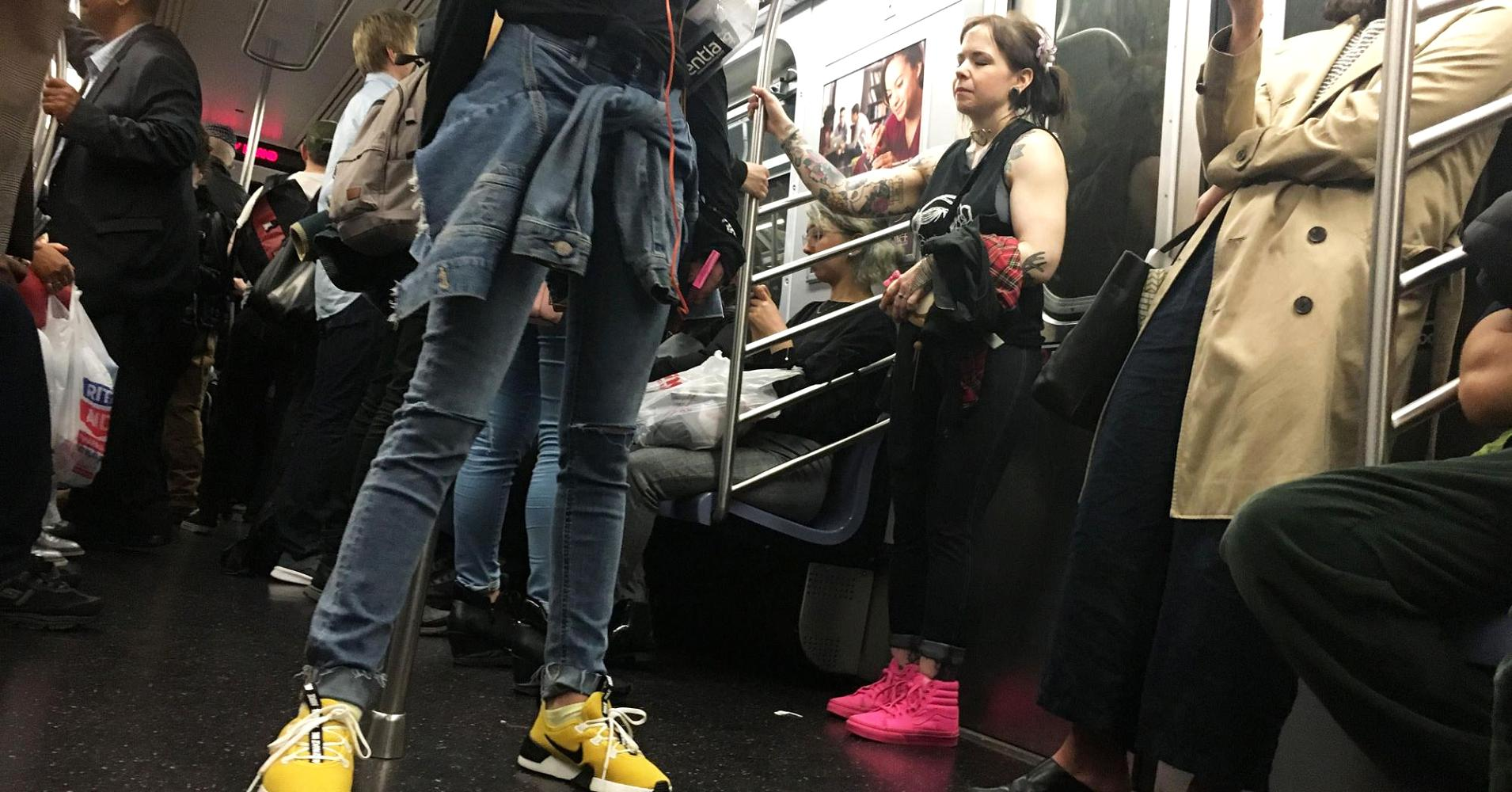 Even in large metropolitan areas, women are choosing comfortable footwear. Women ride the subway in New York City wearing a variety of sneakers and flats. Photo: Kellie Ell/CNBC