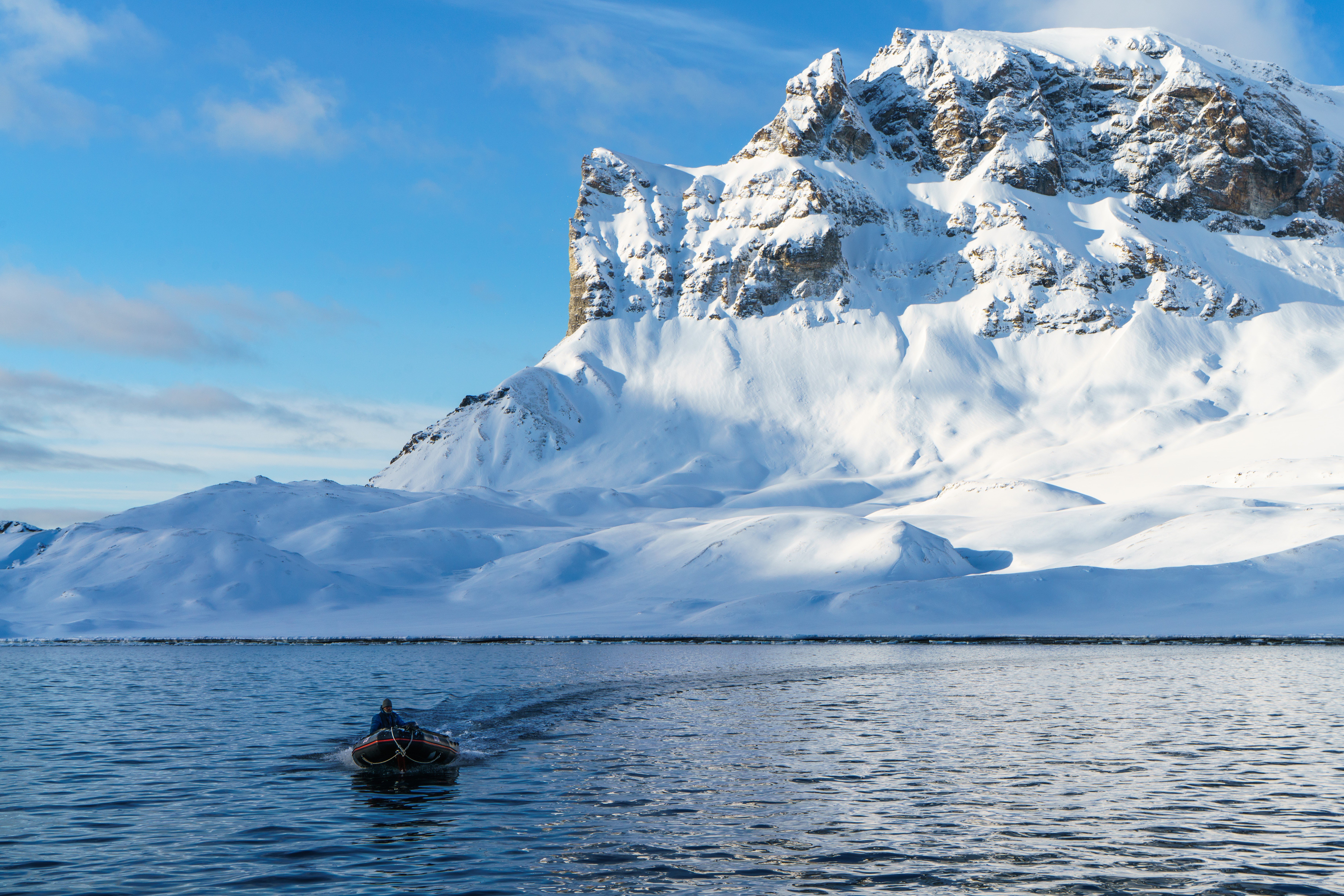 Robert Wolting, first mate of the Arctic expedition sailing ship Noorderlicht, returns in a Zodiac boat from reconnoitring a landing on Alkhornet mountain in Spitsbergen, Norway. Photo: Tessa Chan