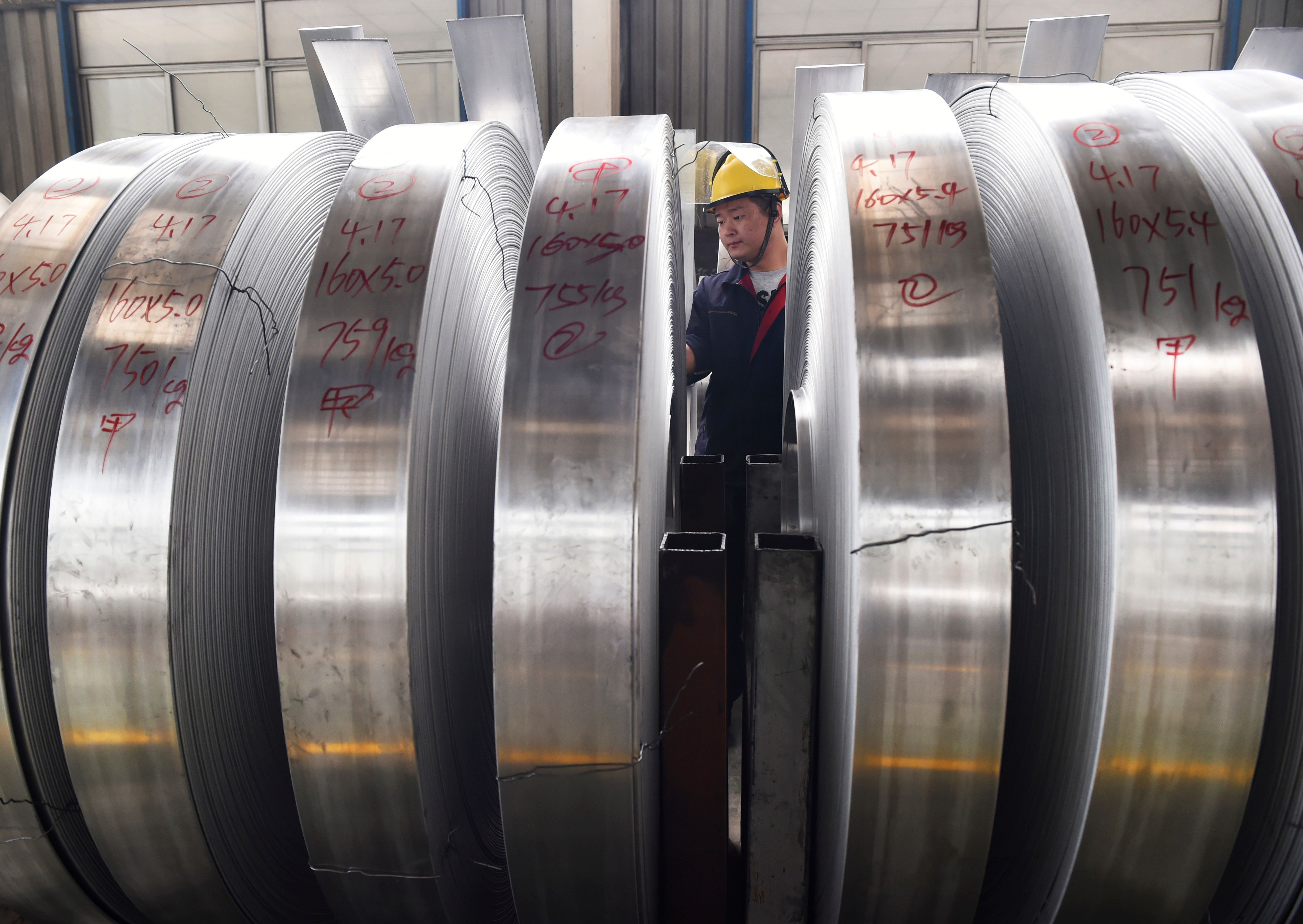 A worker checks rolls of aluminium at a factory in China's eastern Shandong province. Photo: AFP