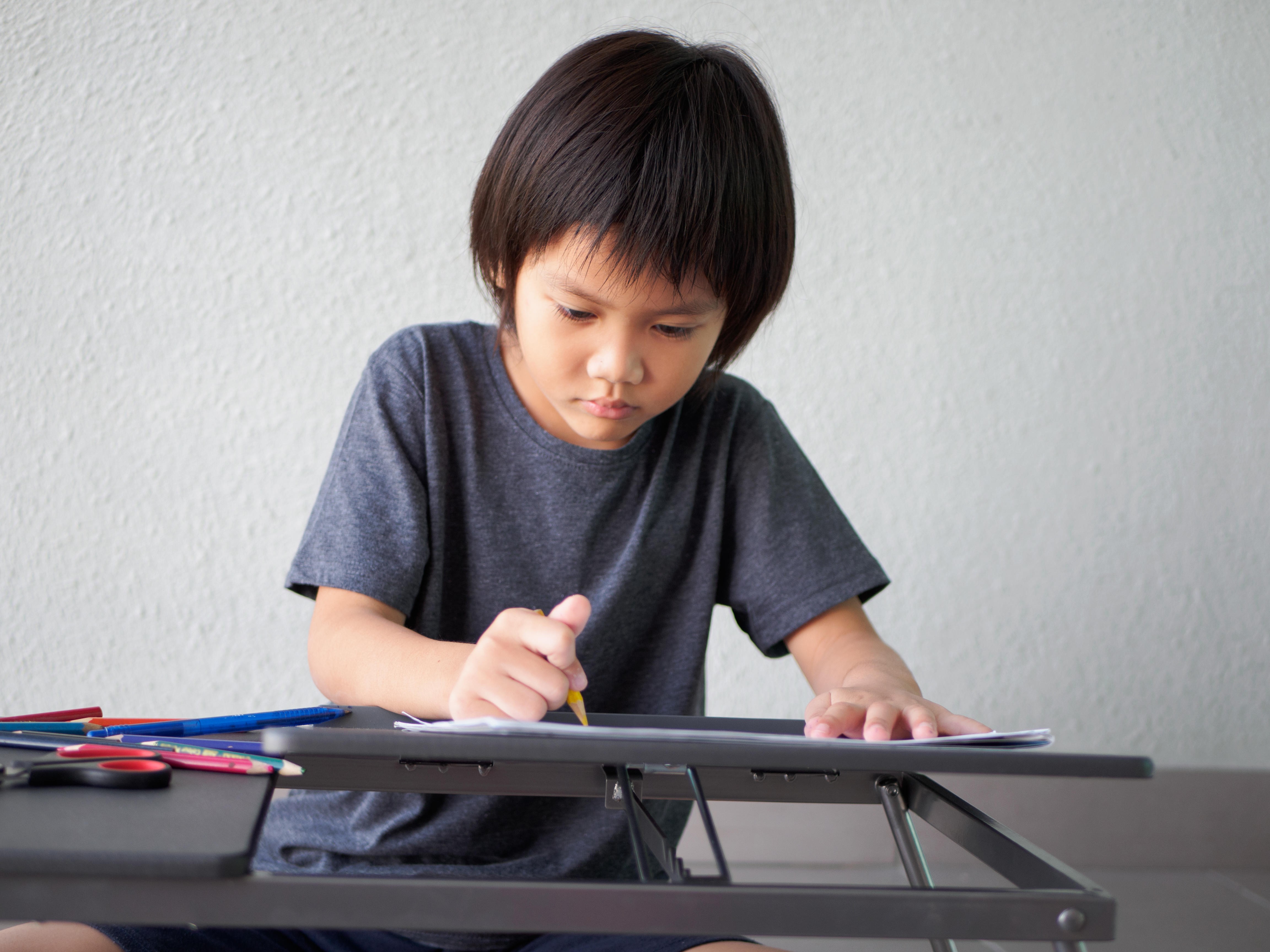When a child wants to do their homework by themselves they are showing independence and developing their self-organisation skills. Photo: Alamy