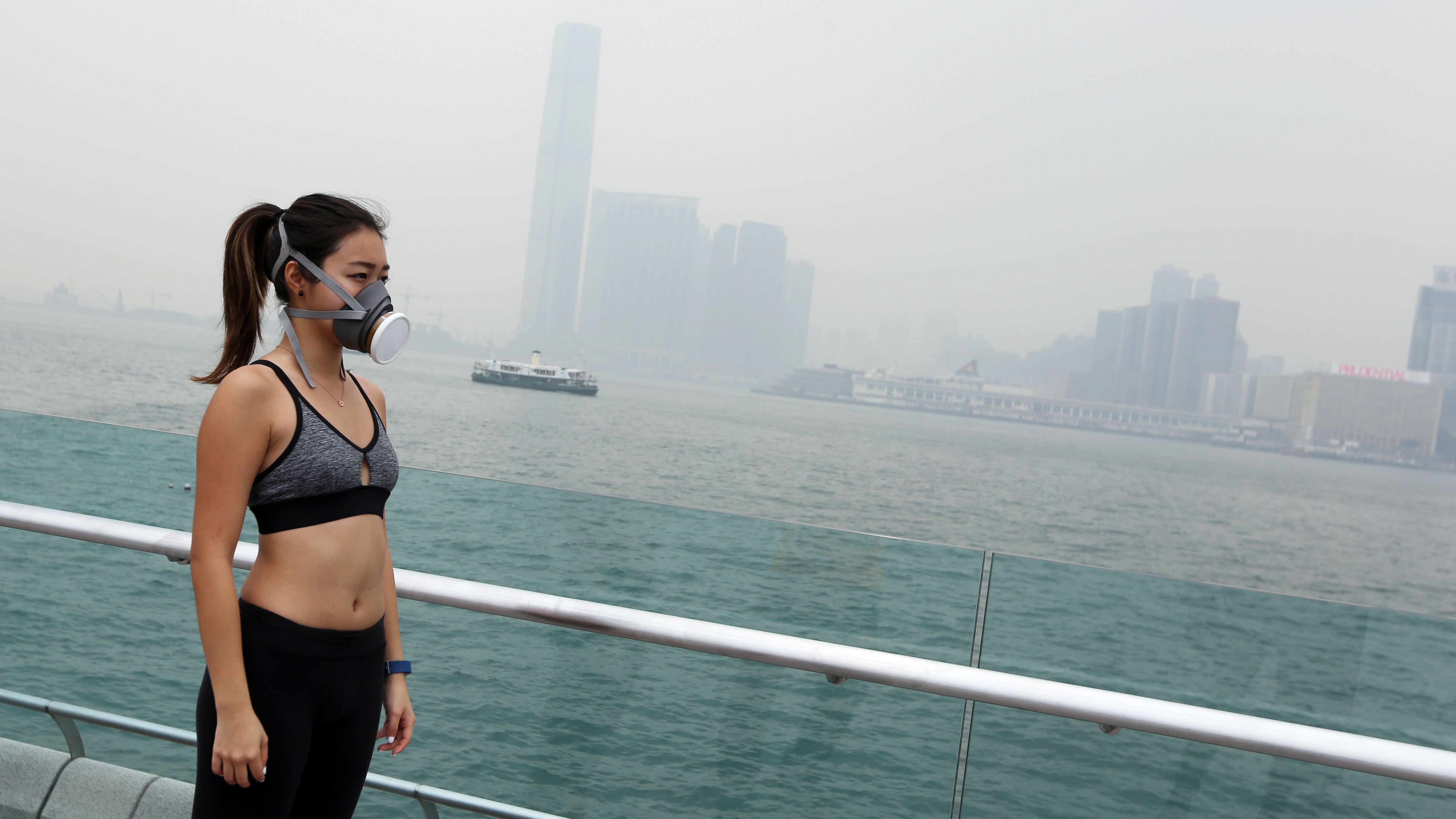 A woman running with a mask on a polluted day in Hong Kong. Photo: Xiaomei Chen