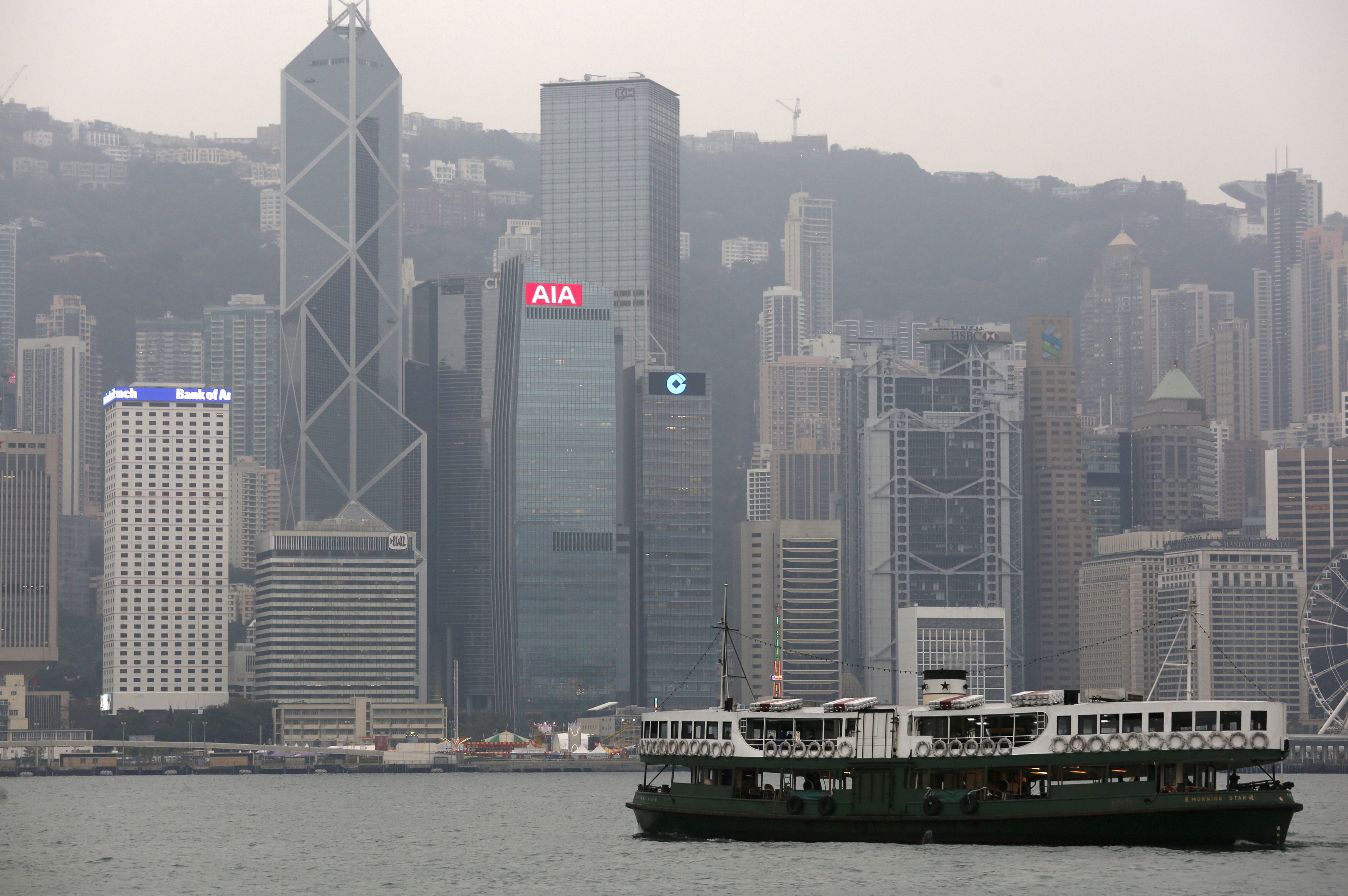 A ferry sails at Victoria Harbour in front of the Central financial district. Photo: Reuters